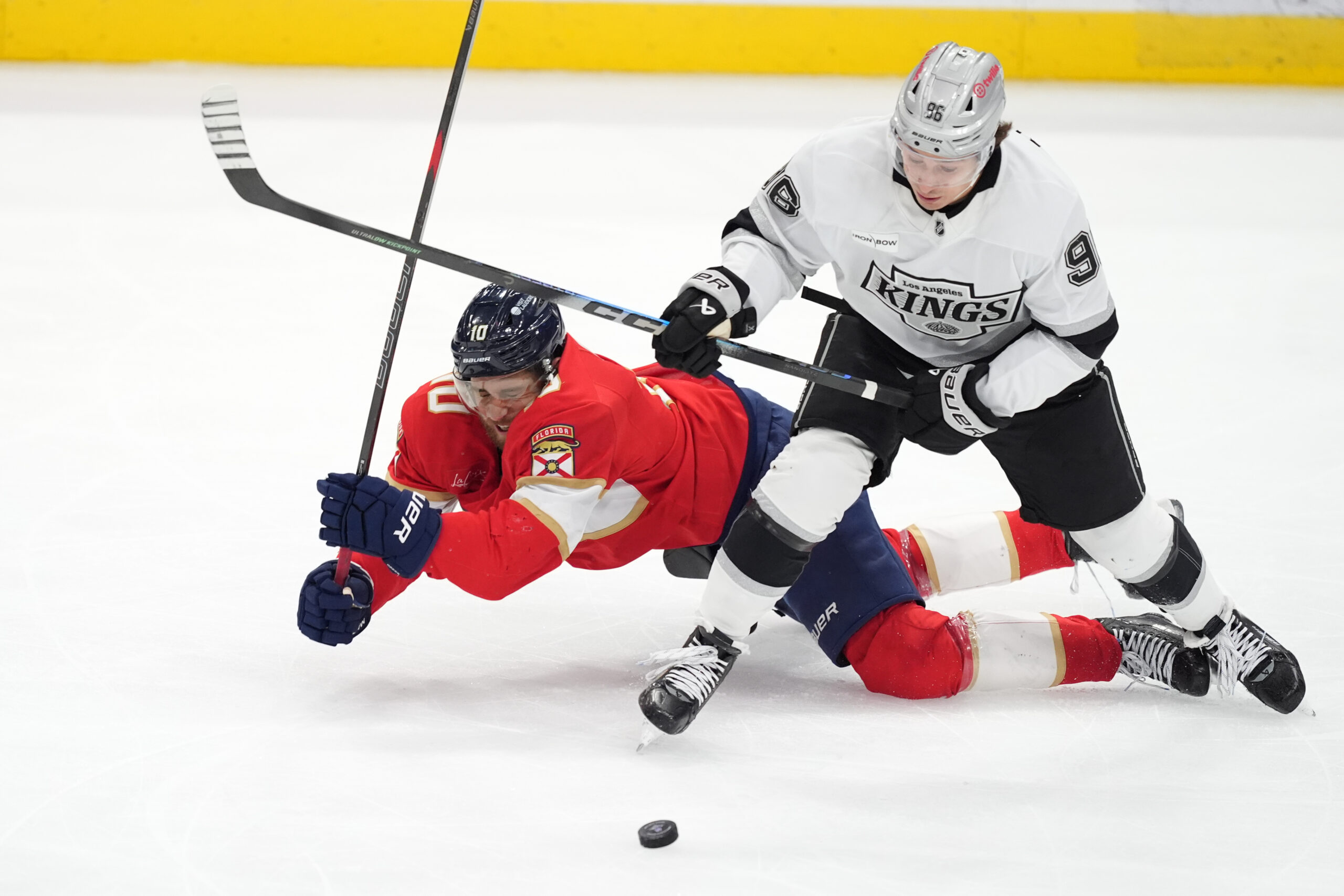 Florida Panthers left wing A.J. Greer, left, falls to the...