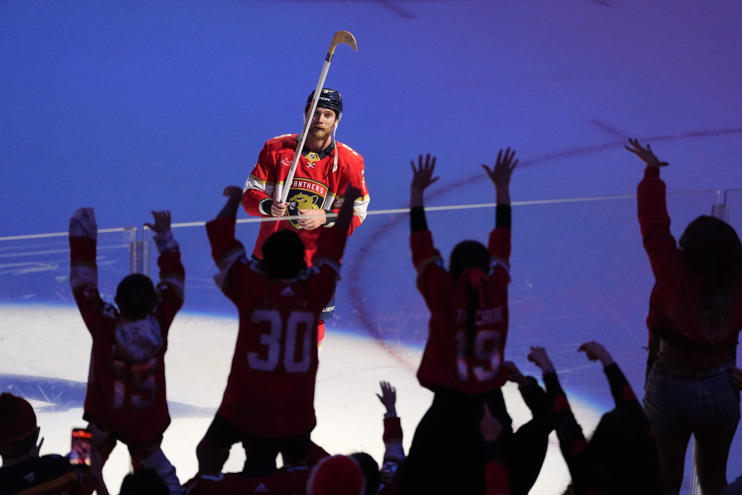 Florida Panthers center Sam Bennett hands off his stick to...