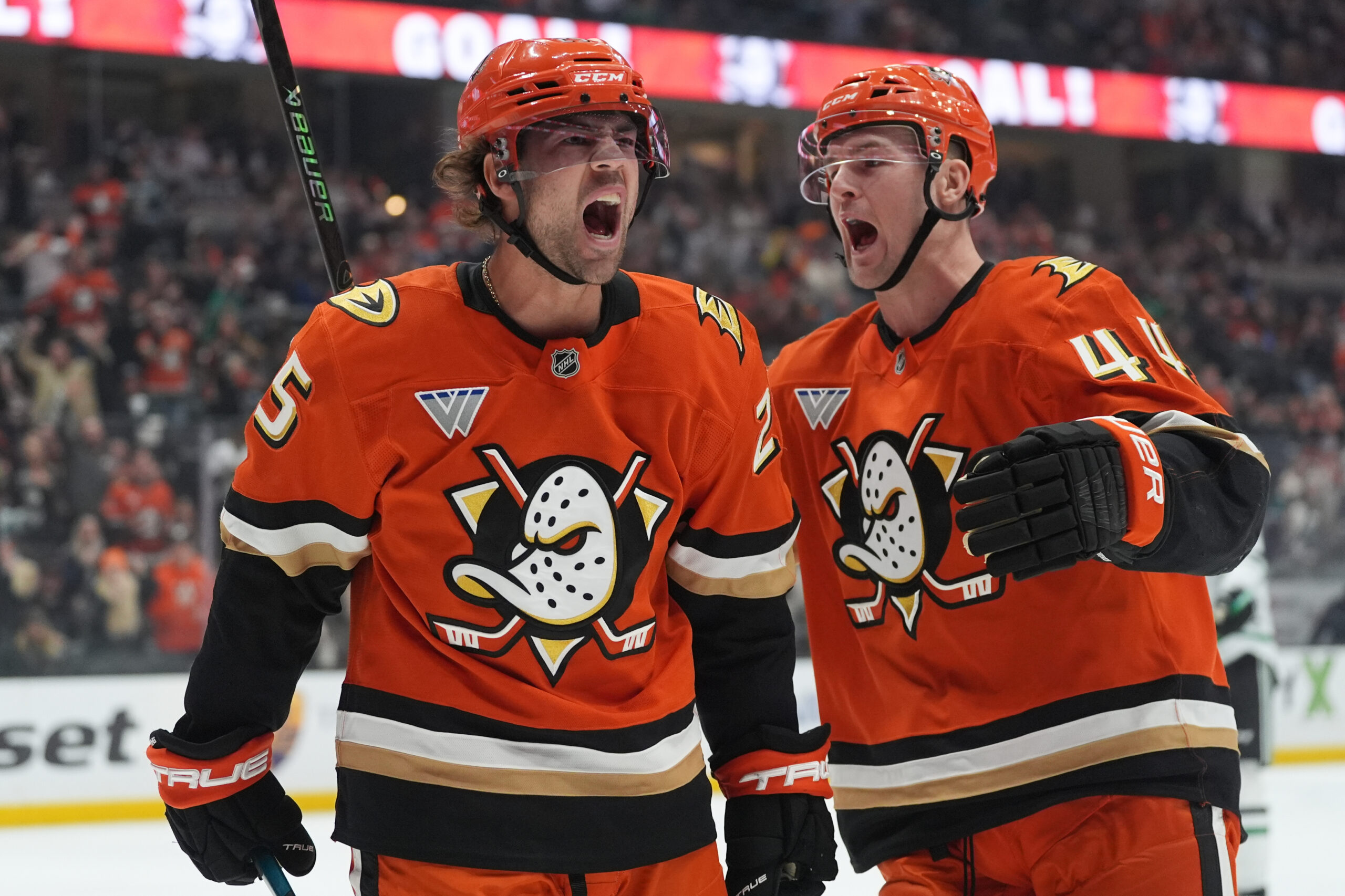 Ducks center Ryan Poehling, left, celebrates his goal with left...