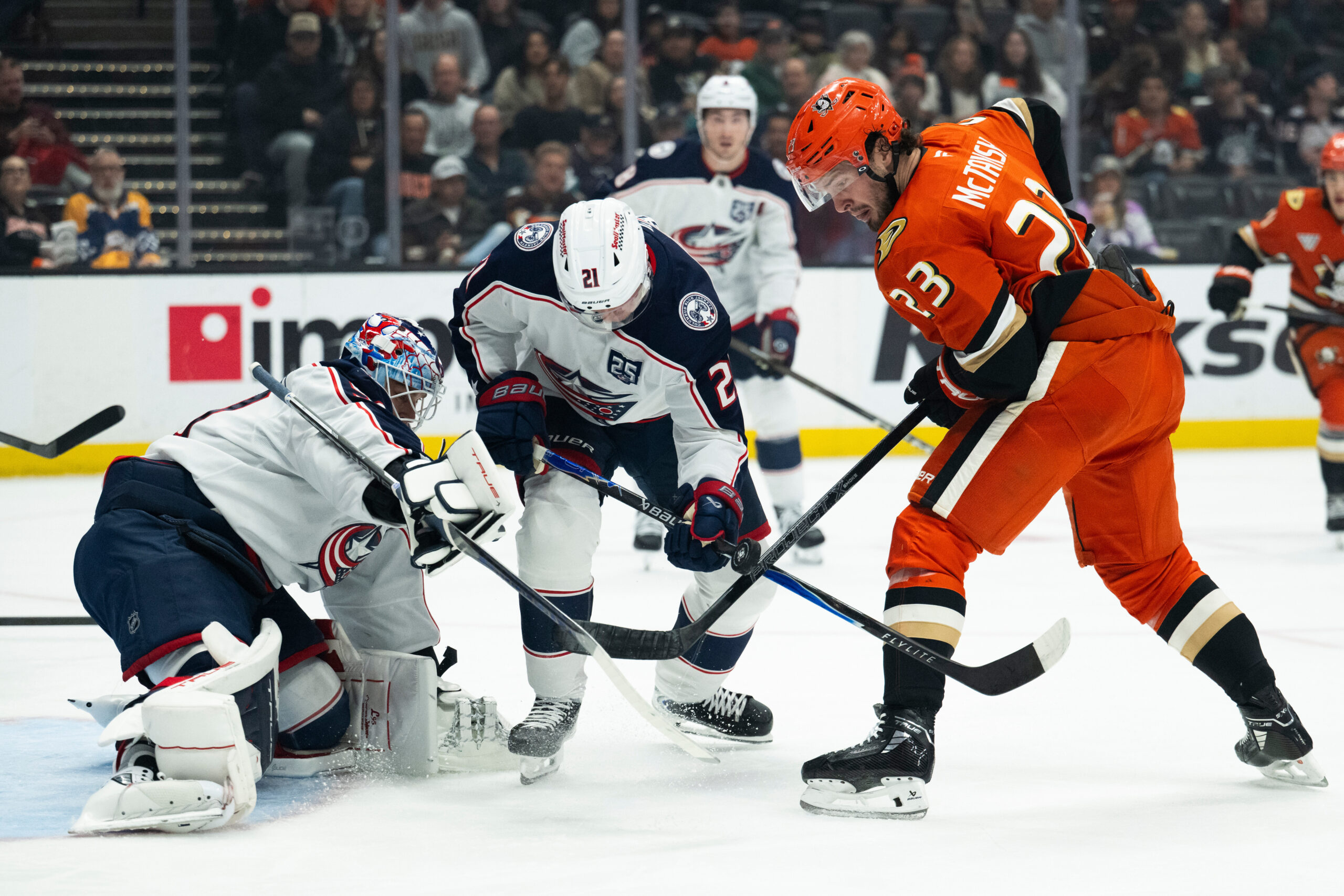 Columbus Blue Jackets goaltender Elvis Merzlikins, left, and center Isac...