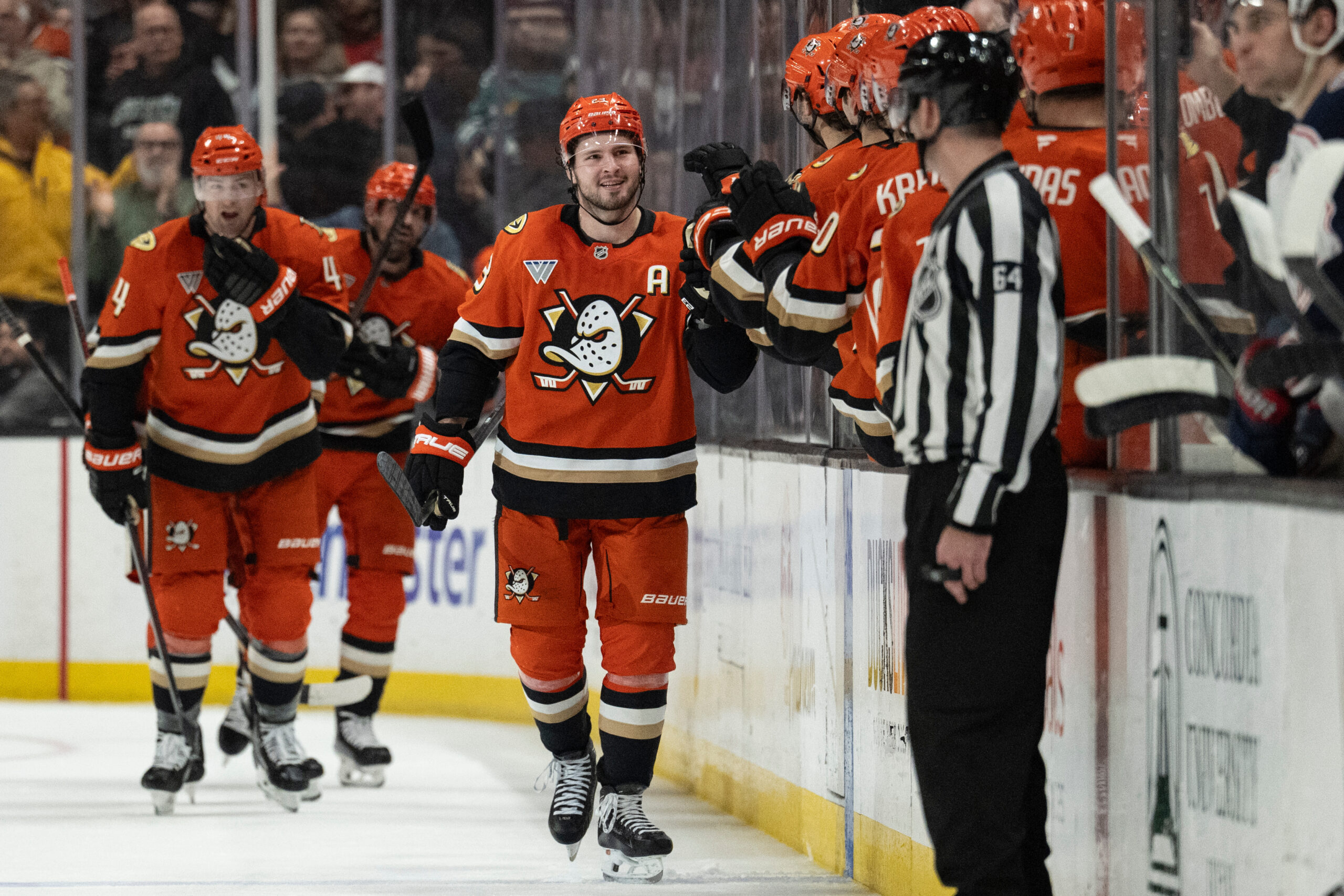 Ducks center Mason McTavish, center, celebrates with the bench after...