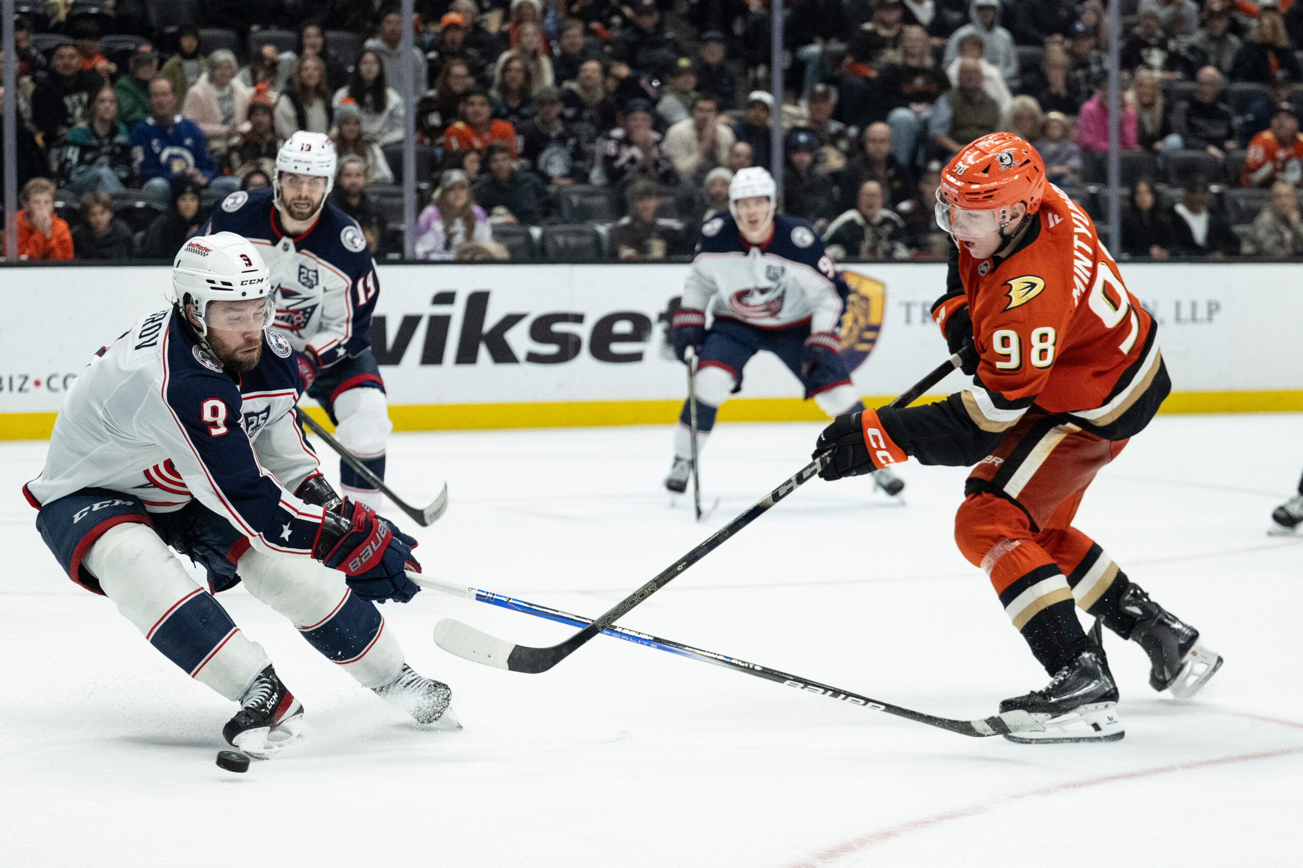 Ducks defenseman Pavel Mintyukov, right, shoots the puck as Columbus...
