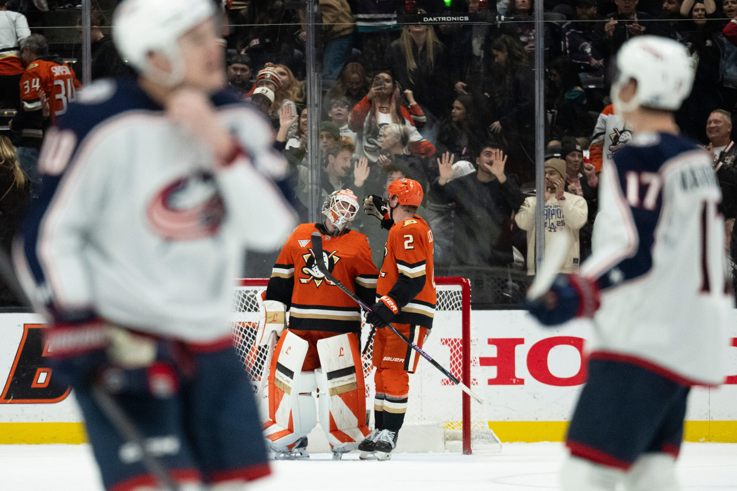 Ducks goaltender Lukas Dostal, left, and defenseman Jackson Lacombe celebrate...