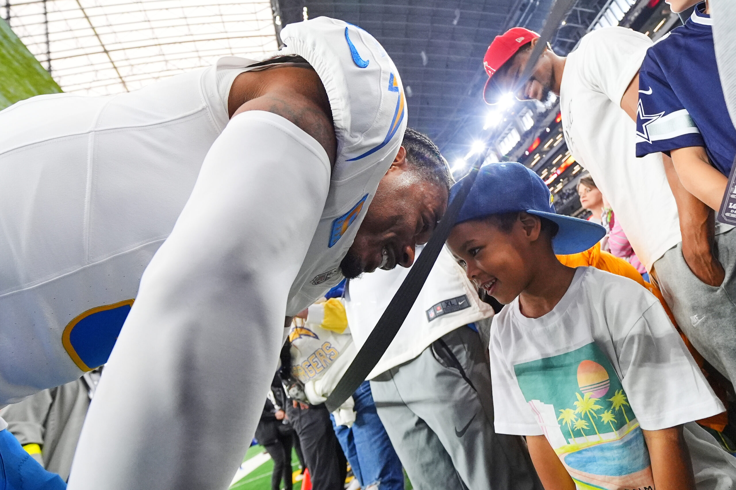 Chargers free safety Derwin James (3) talks to his son...
