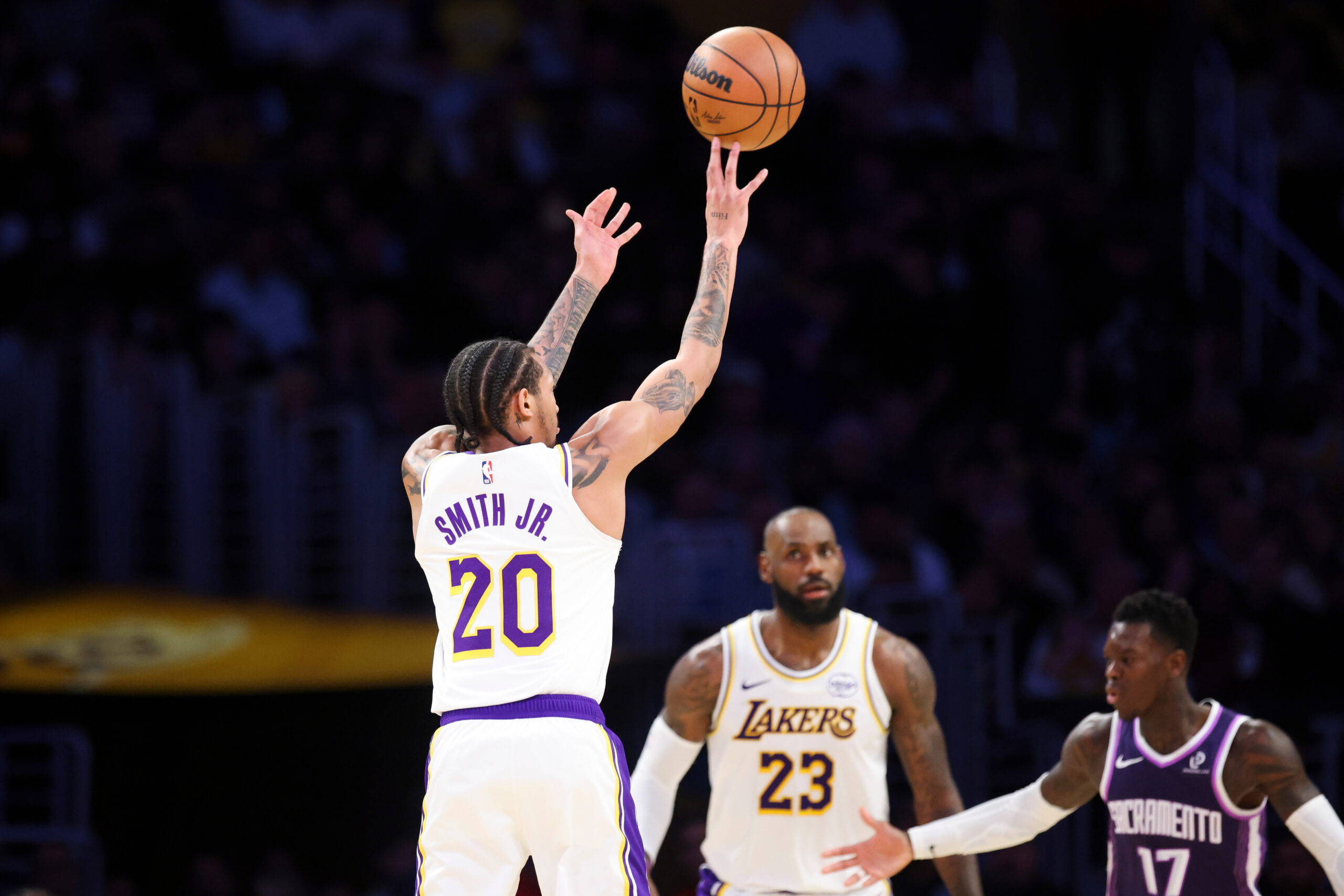 Lakers guard Nick Smith Jr. (20) shoots as forward Lebron...