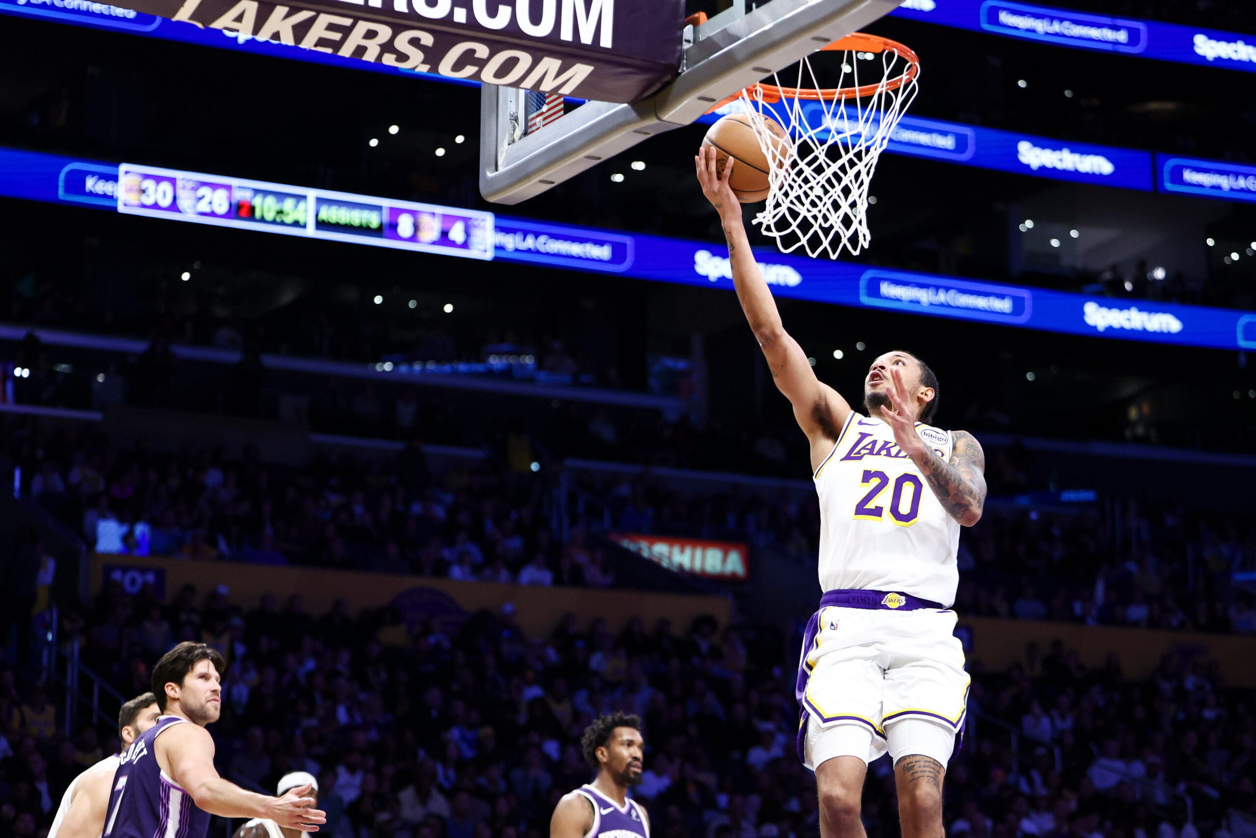 Lakers guard Nick Smith Jr. (20) drives to the basket...