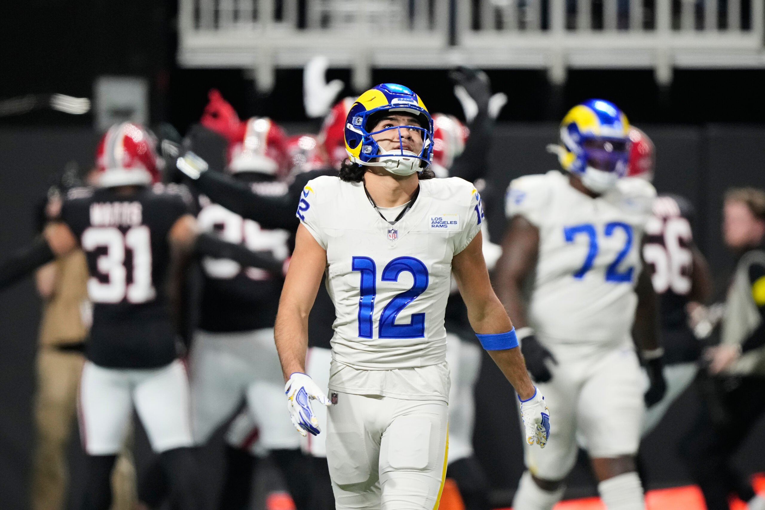 Rams wide receiver Puka Nacua (12) reacts after a pick-six...