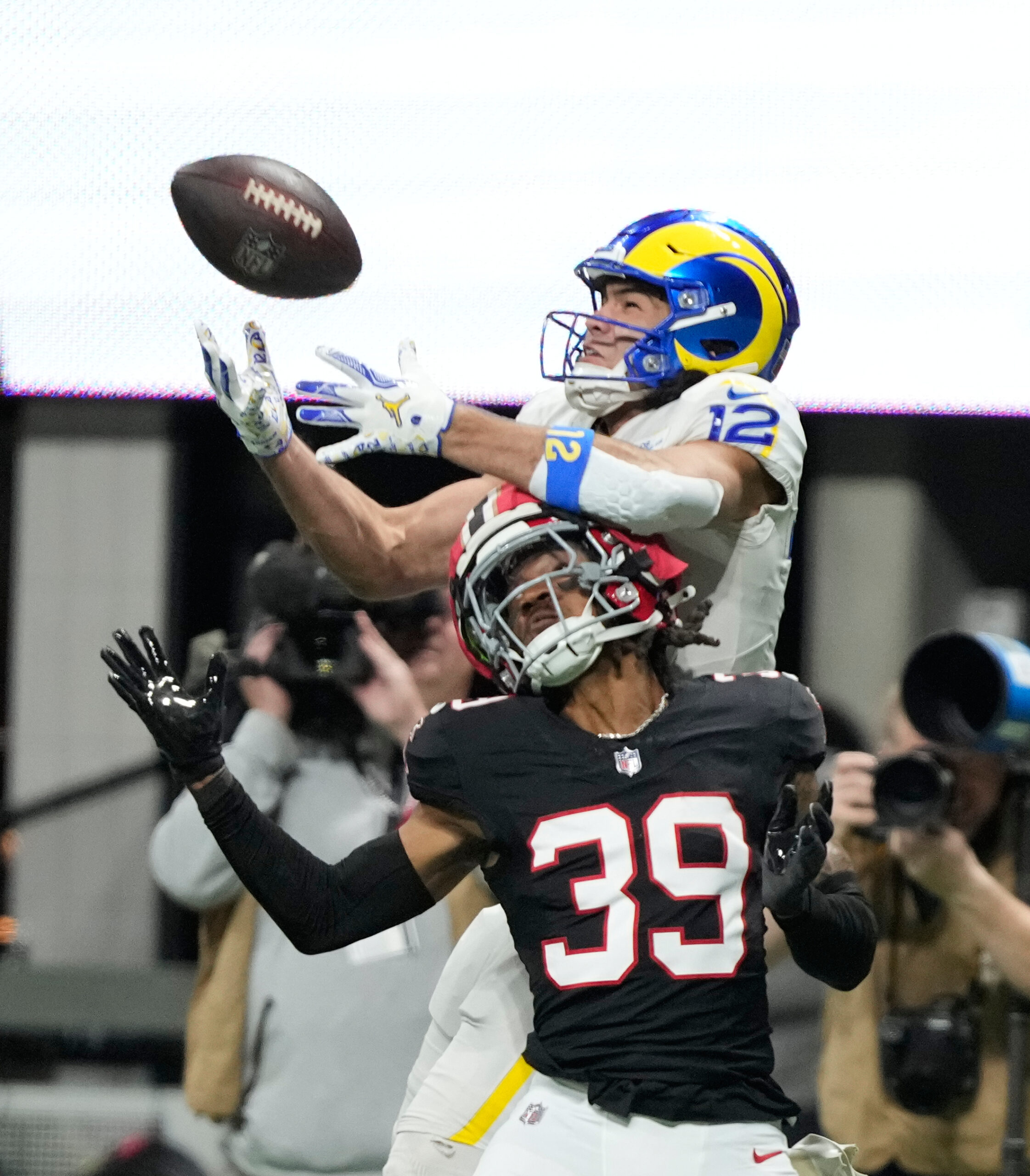 Rams wide receiver Puka Nacua (12) pulls in a long...