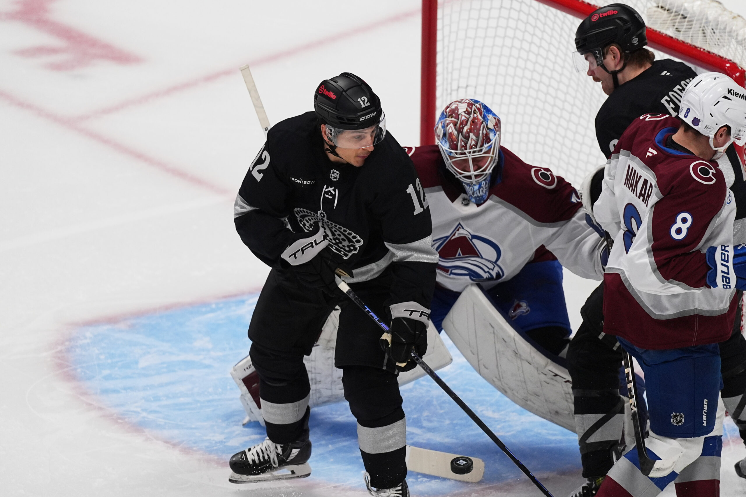 Kings left wing Trevor Moore, front left, redirects the puck...