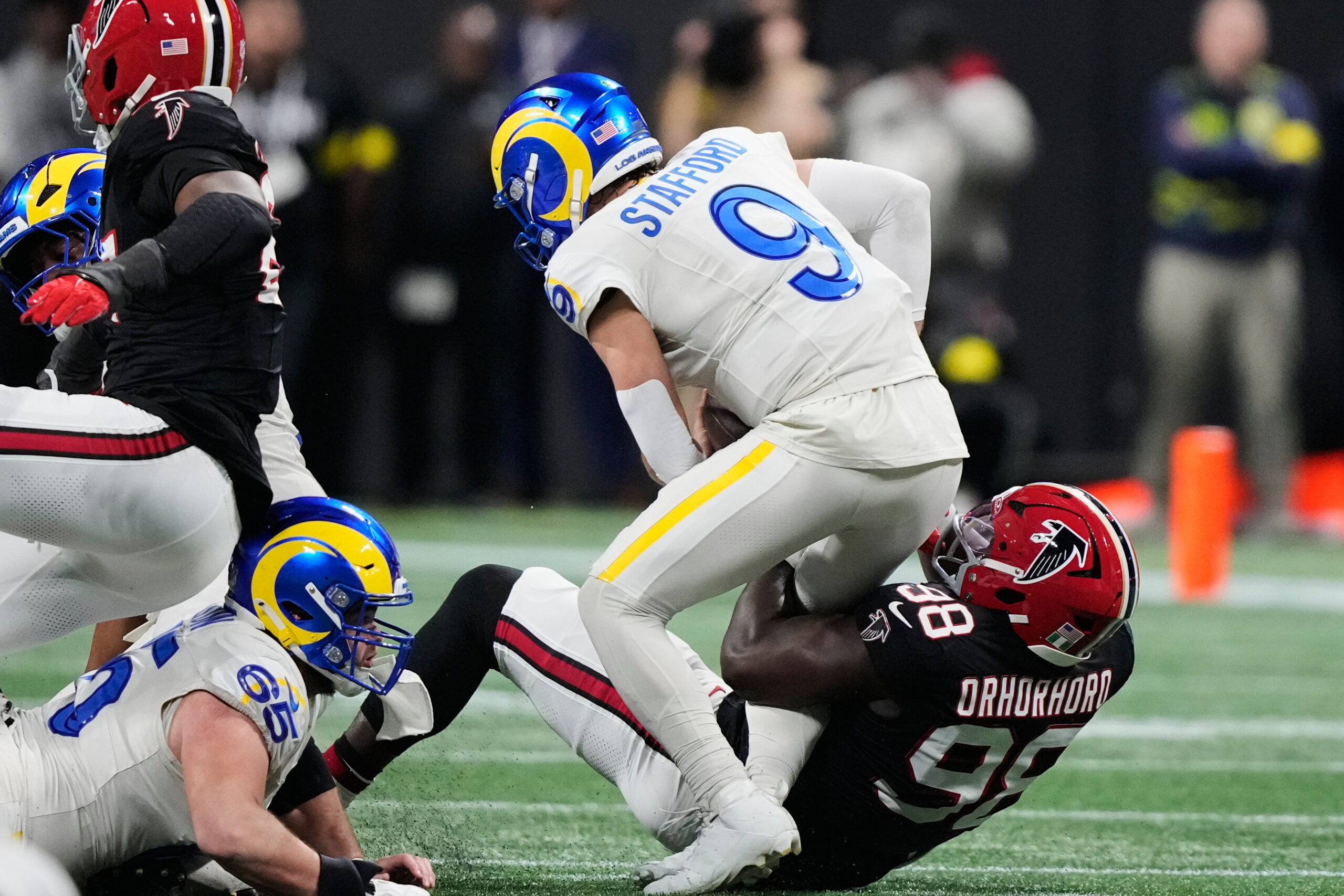 Rams quarterback Matthew Stafford (9) is sacked by Atlanta Falcons...