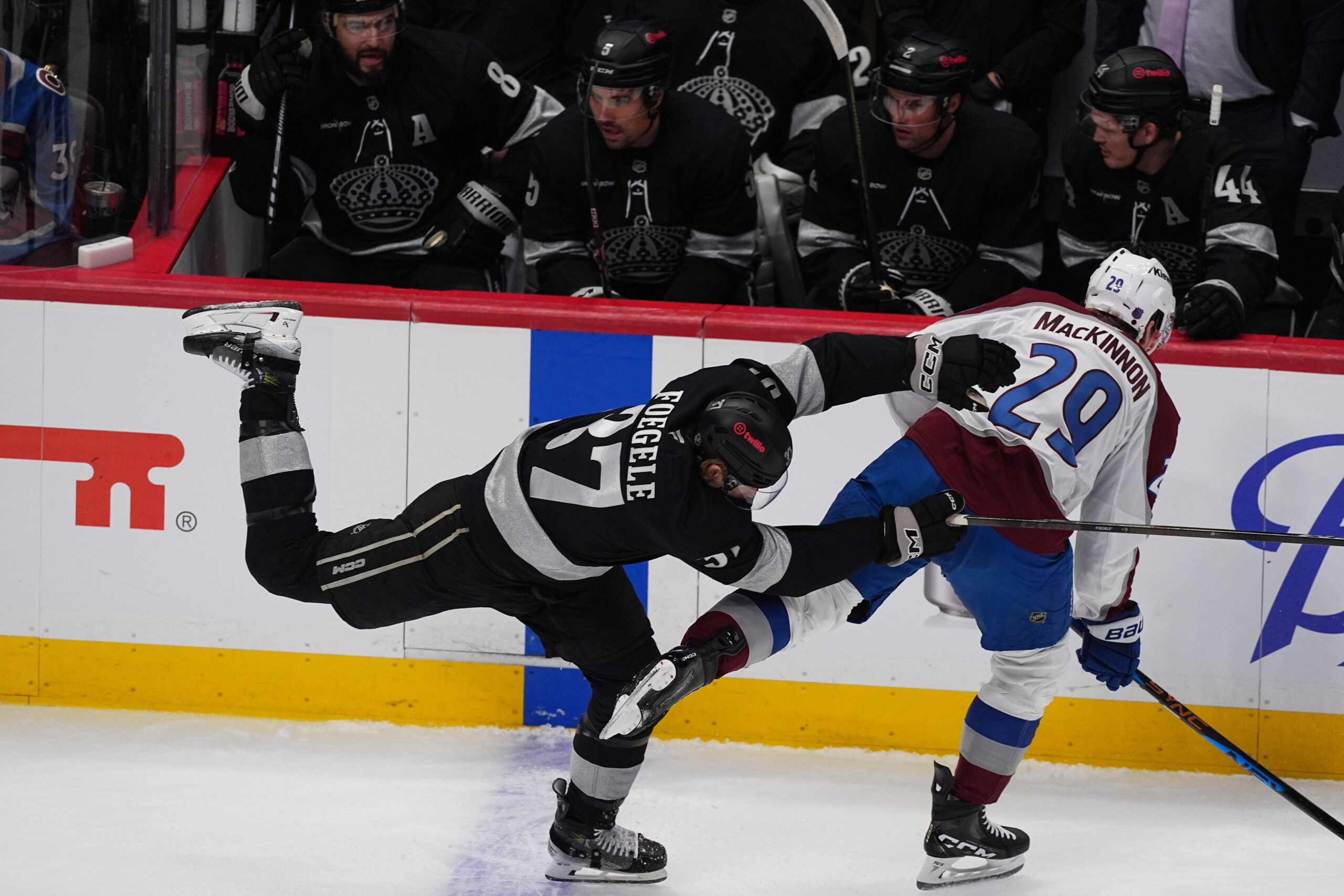 Kings left wing Warren Foegele, left, checks Colorado Avalanche center...