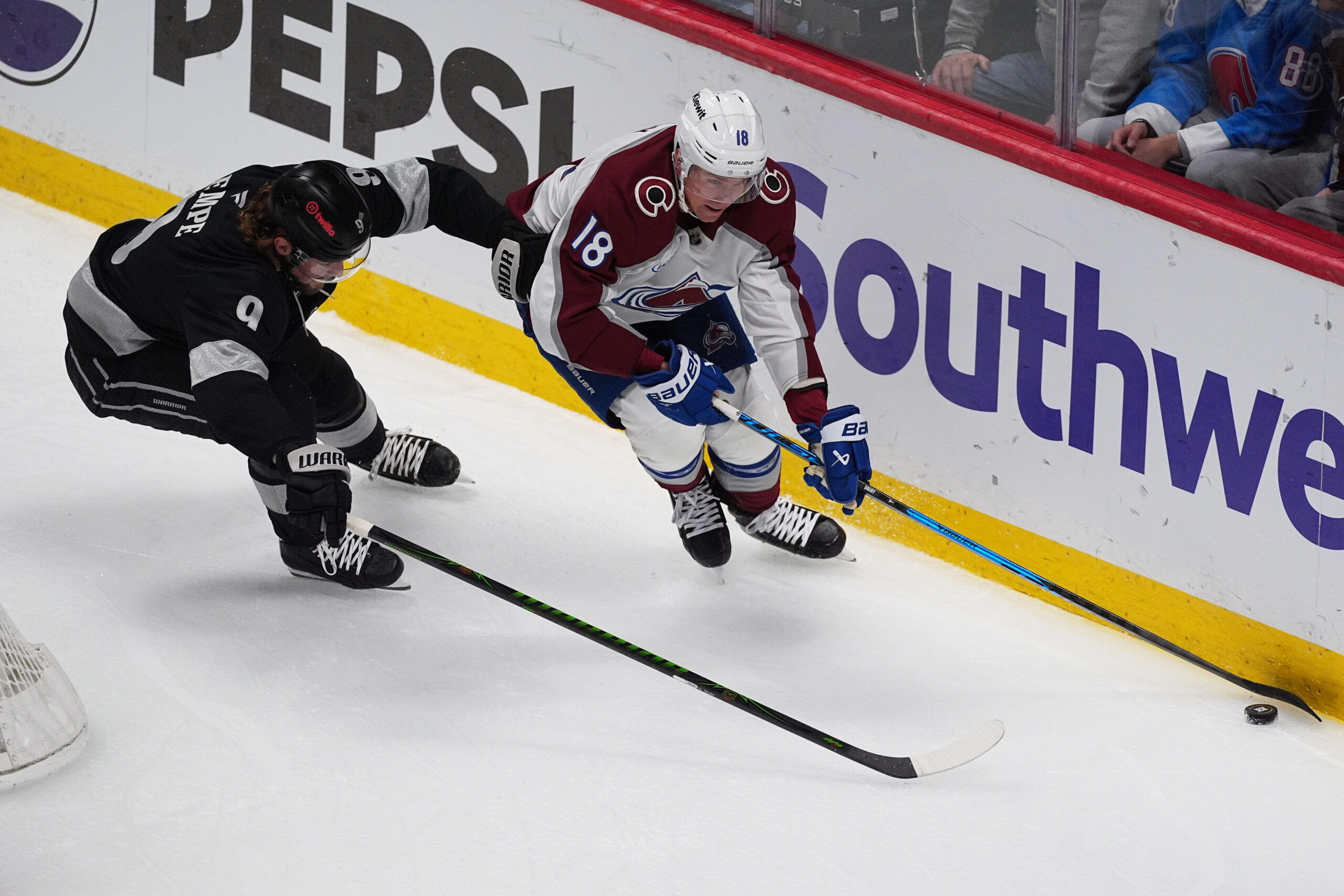 Colorado Avalanche center Jack Drury, right, collects the puck as...