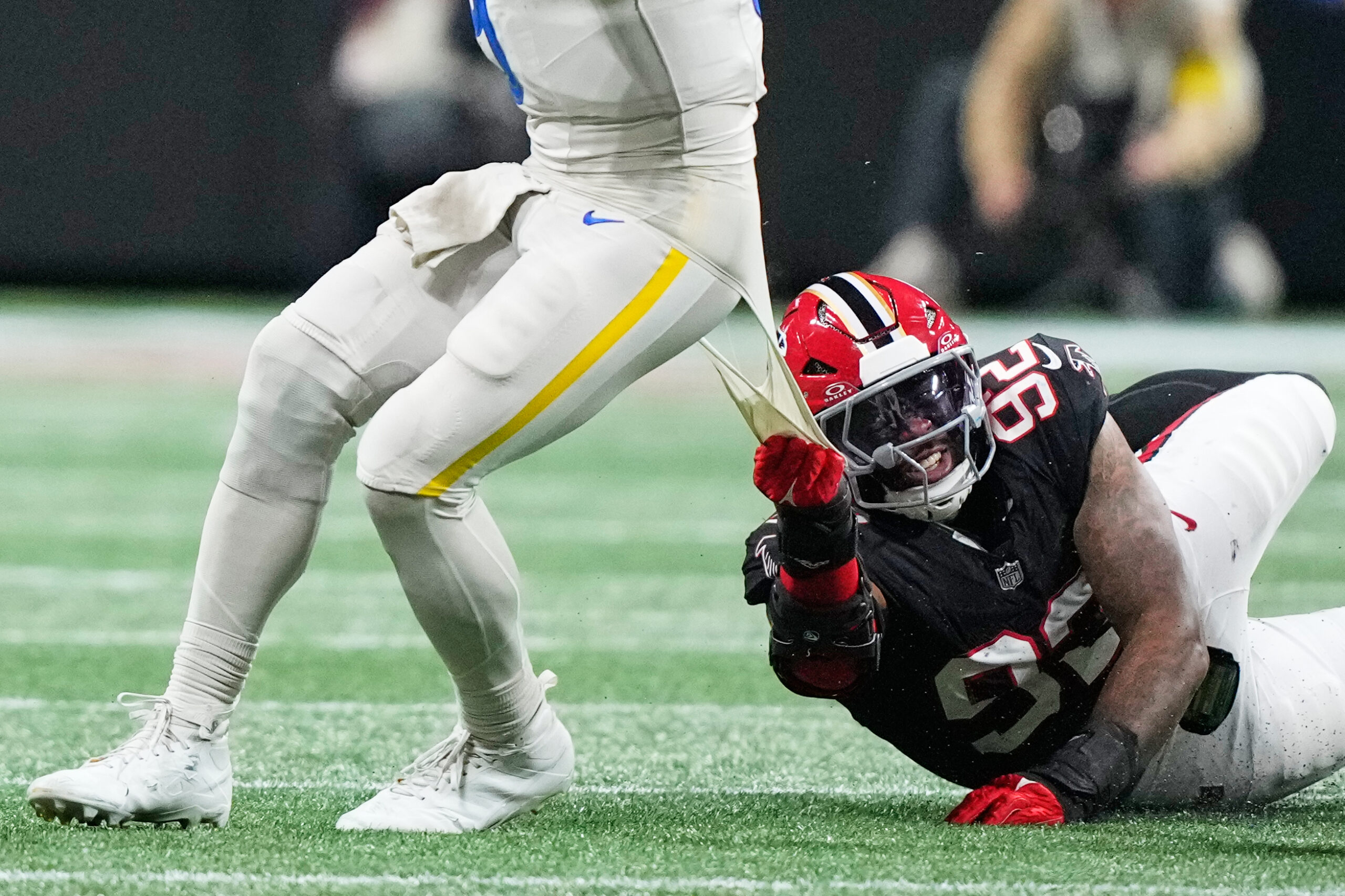 Rams quarterback Matthew Stafford scrambles from Atlanta Falcons linebacker Khalid...