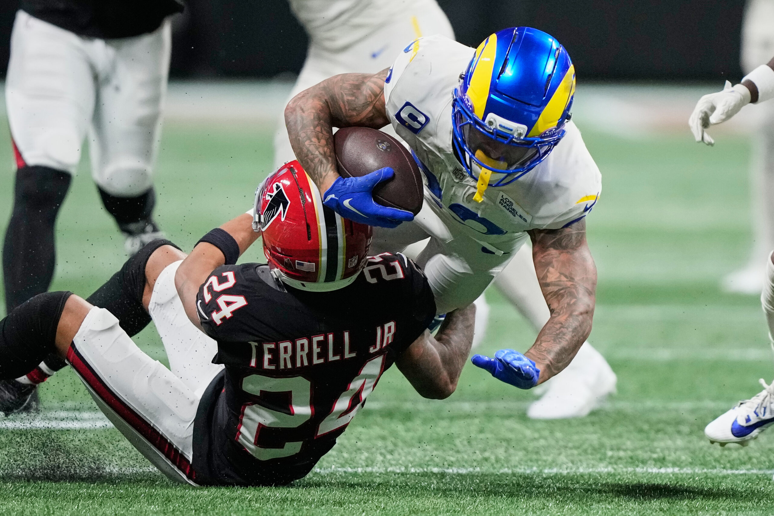 Rams running back Kyren Williams (23) is brought down by...