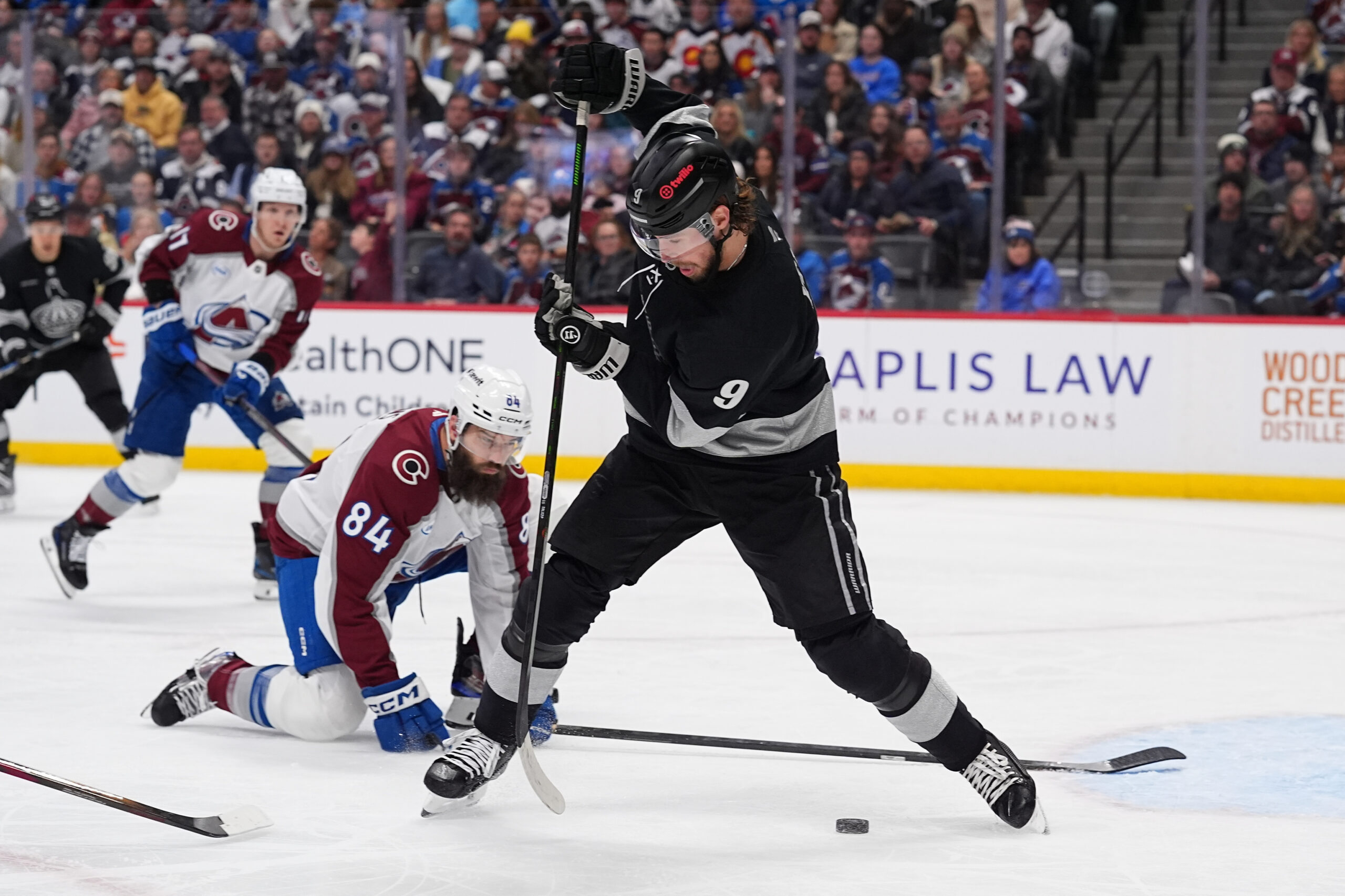 Kings right wing Adrian Kempe, front, redirects the puck as...