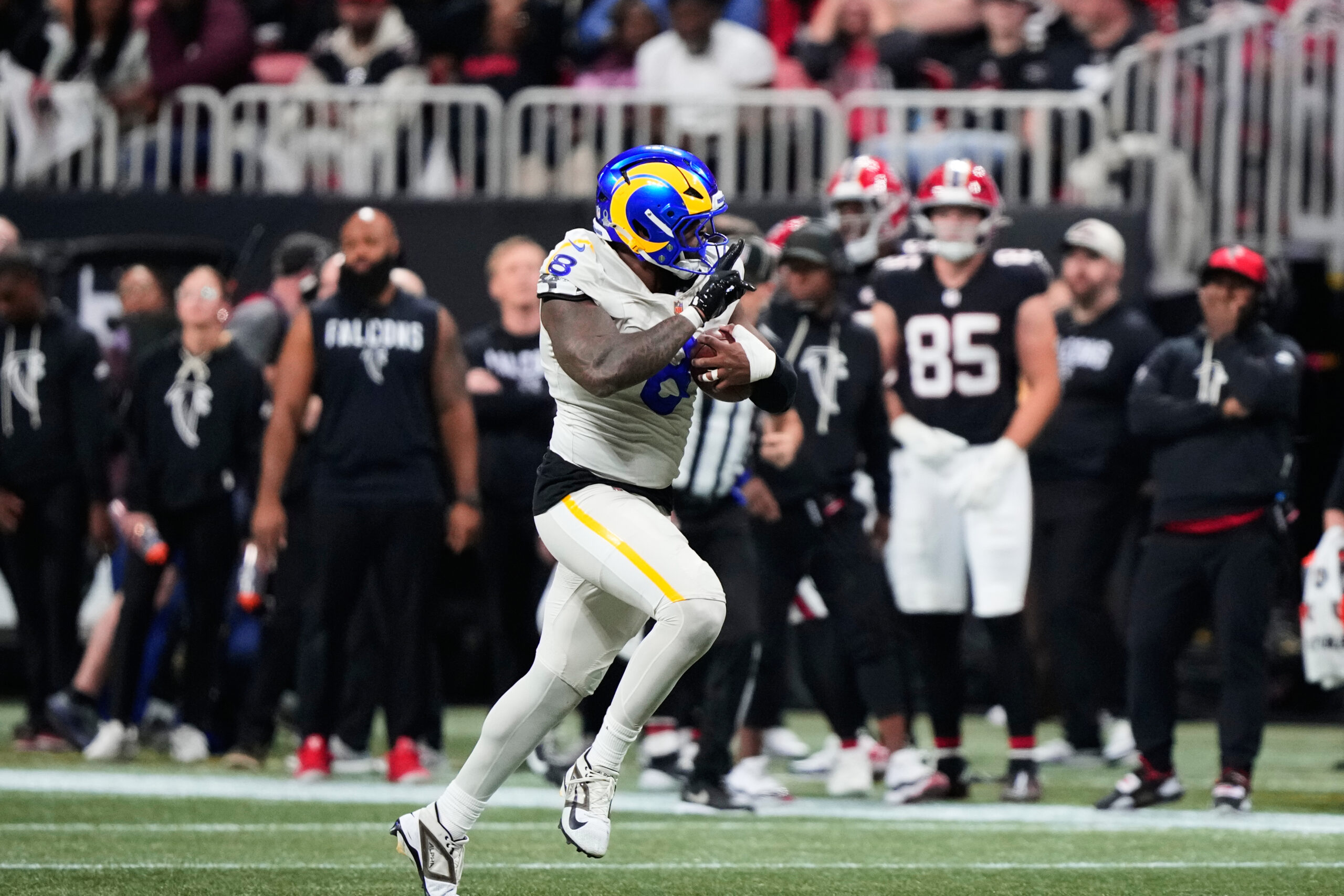 Rams linebacker Jared Verse (8) returns a blocked punt for...