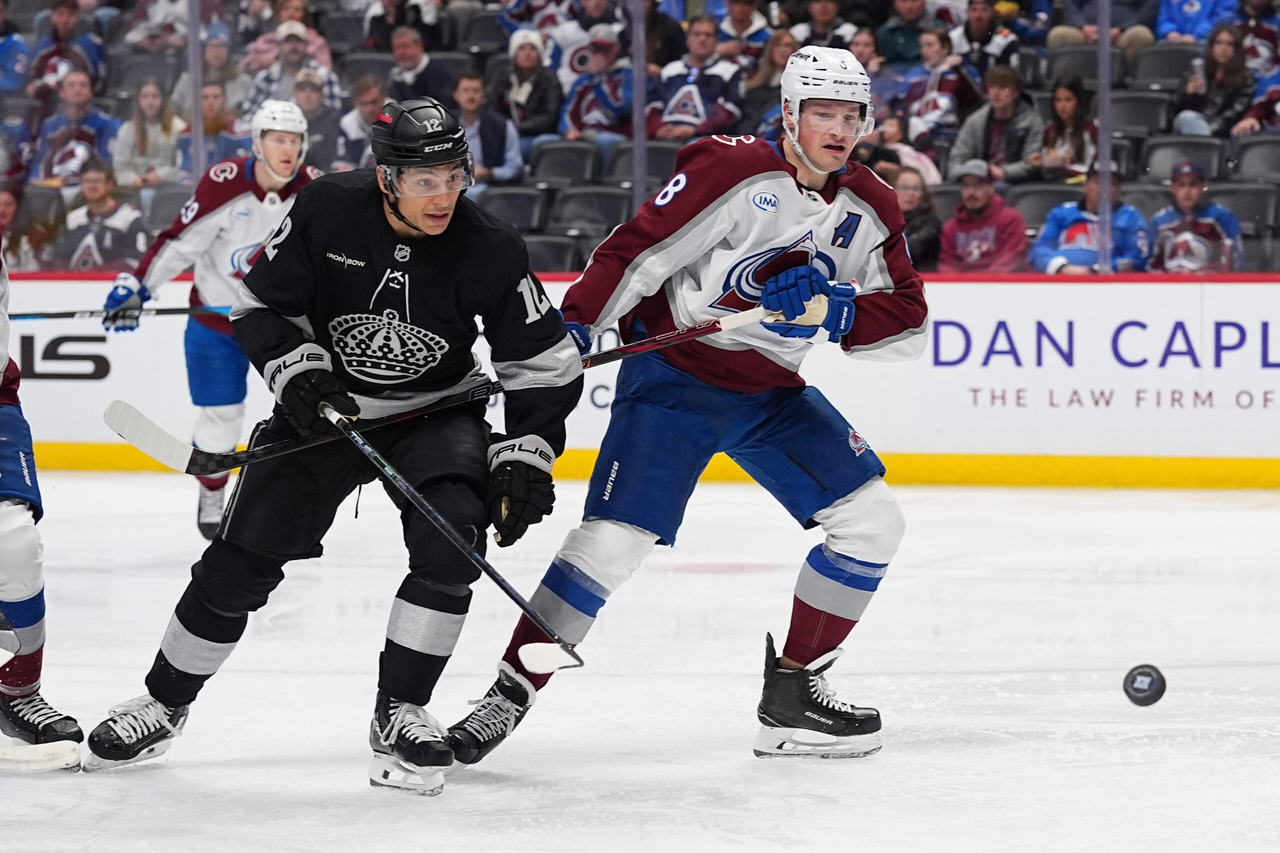Kings left wing Trevor Moore, left, and Colorado Avalanche defenseman...
