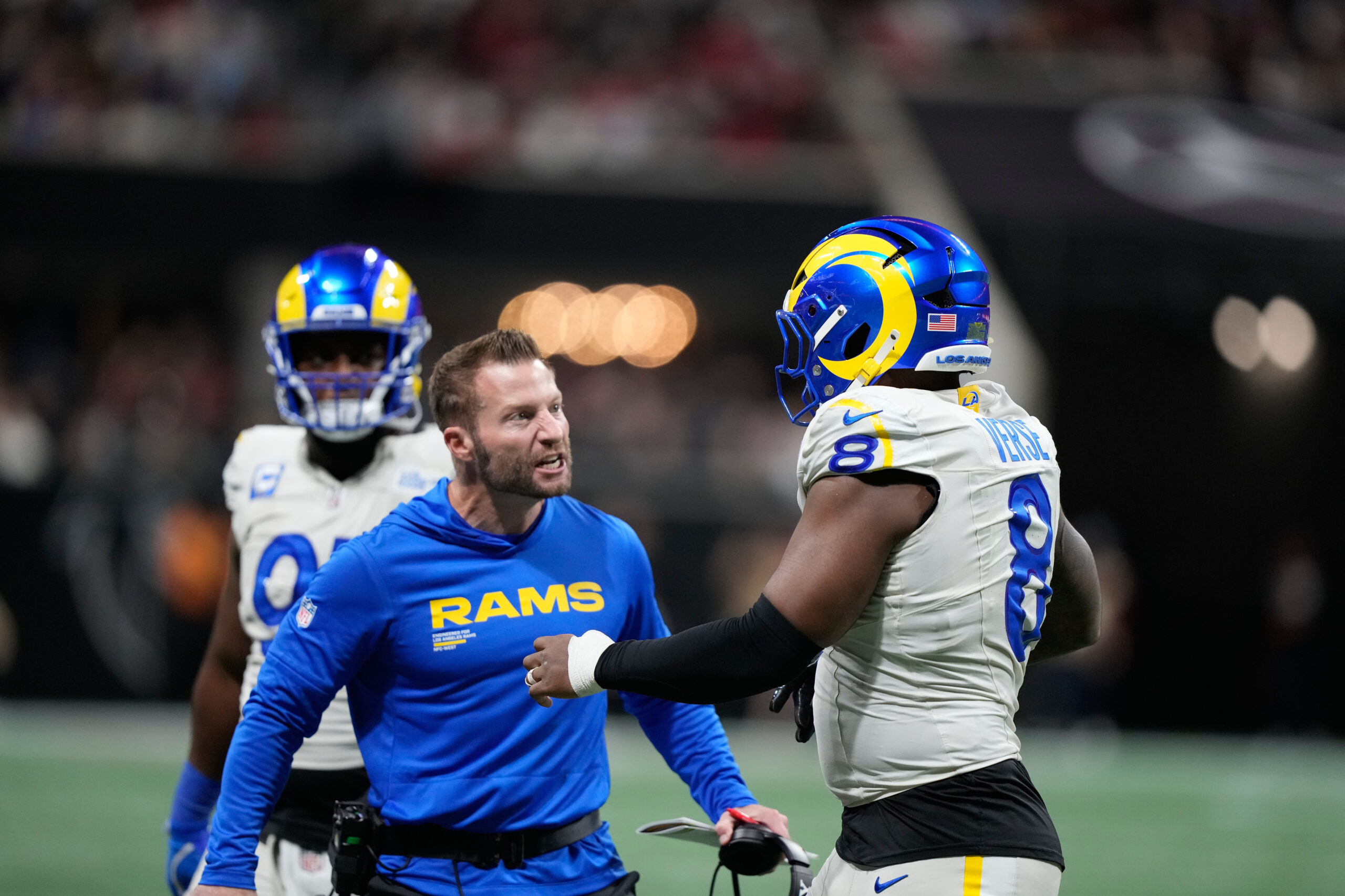 Rams head coach Sean McVay congratulates linebacker Jared Verse (8)...