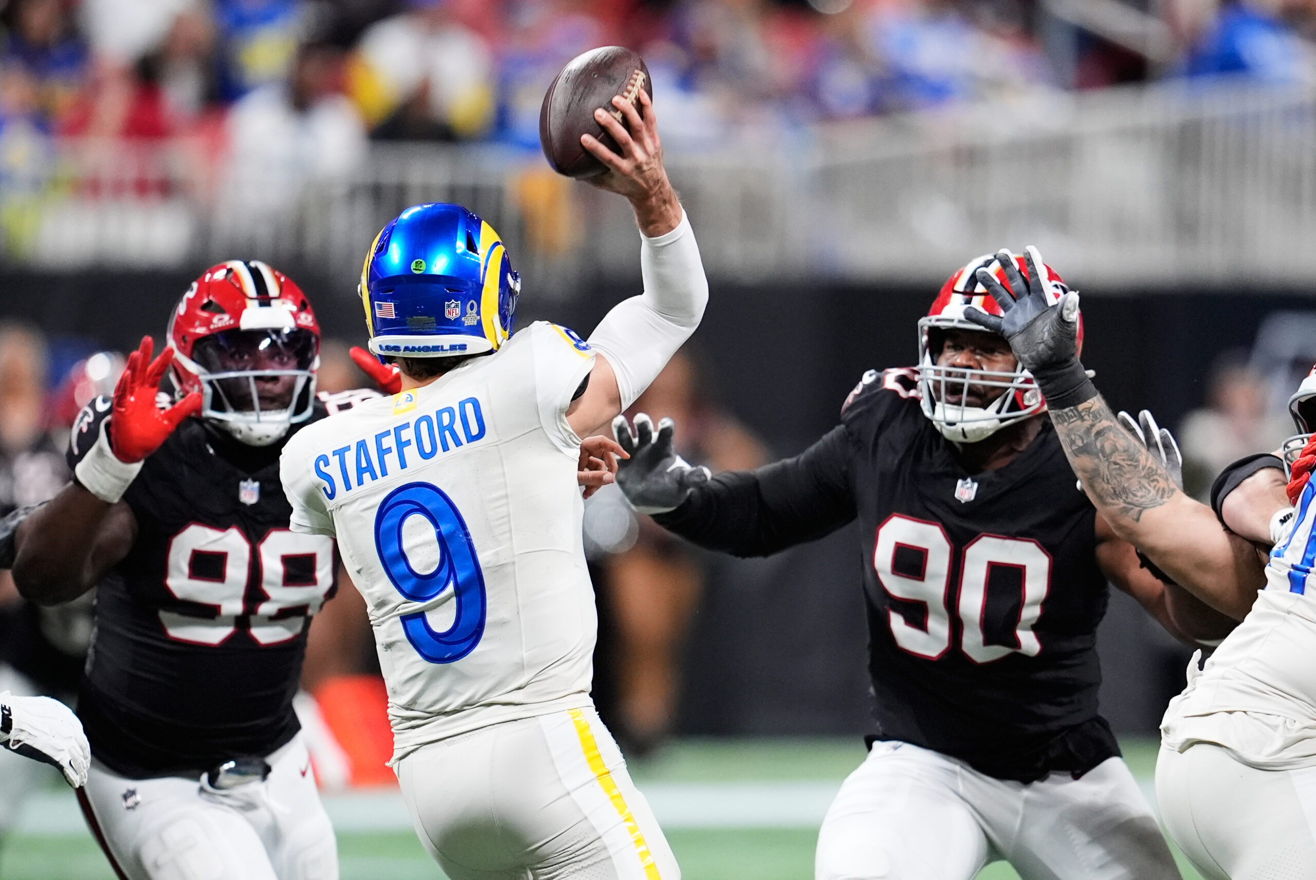 Rams quarterback Matthew Stafford (9) passes under pressure from Atlanta...