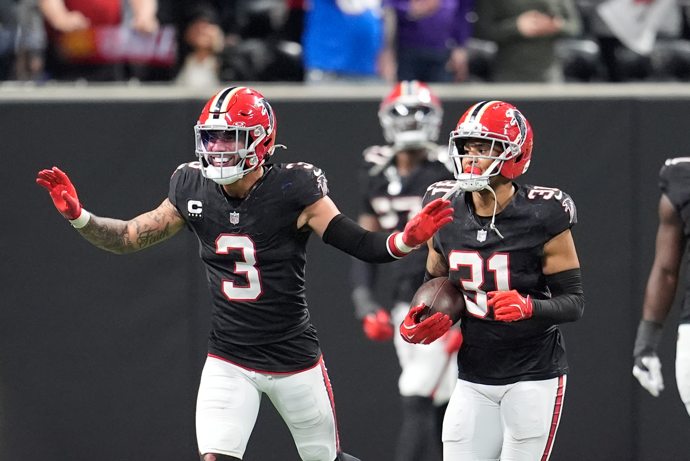 Atlanta Falcons safety Xavier Watts (31) celebrates his interception with...