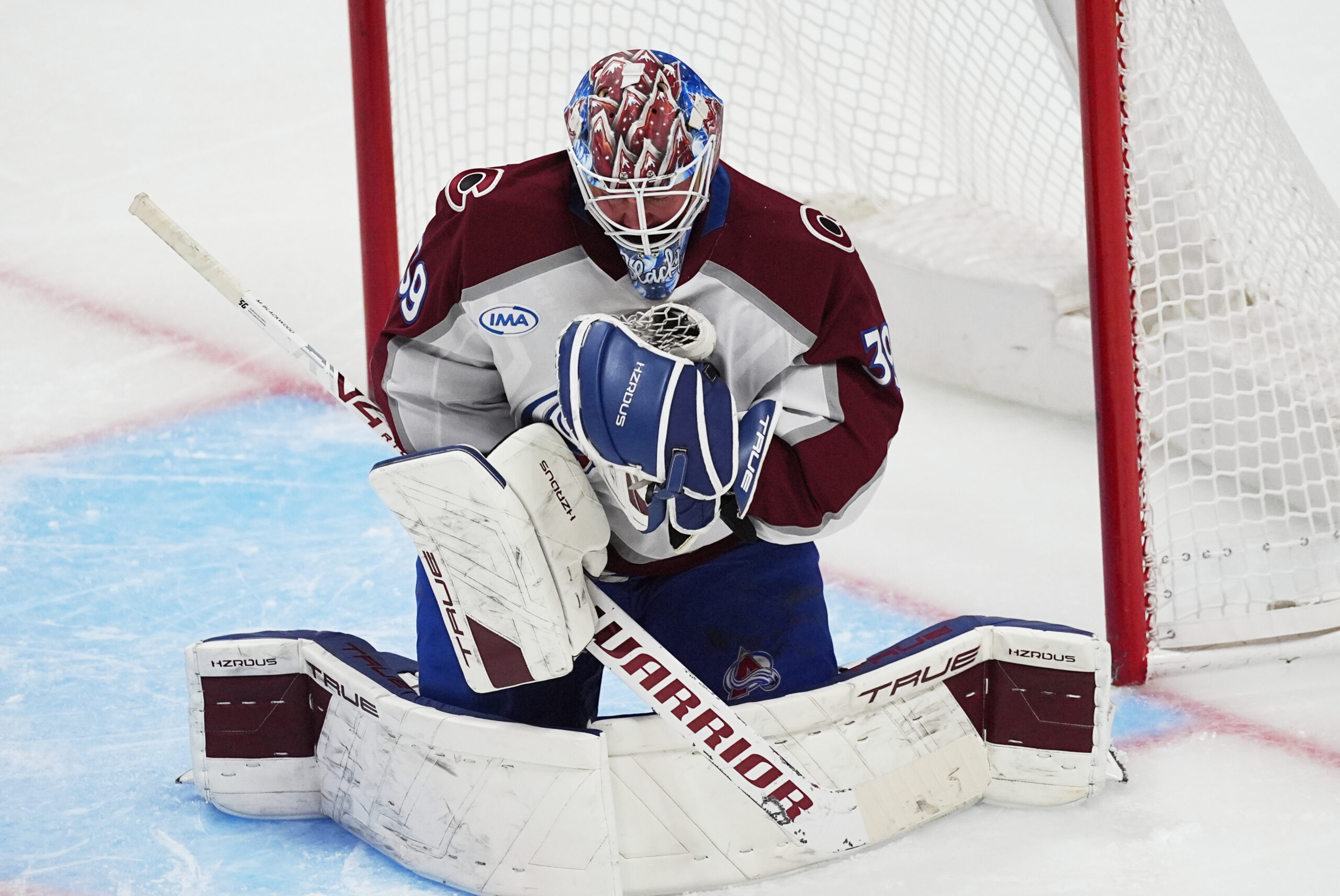 Colorado Avalanche goaltender Mackenzie Blackwood makes a glove save against...