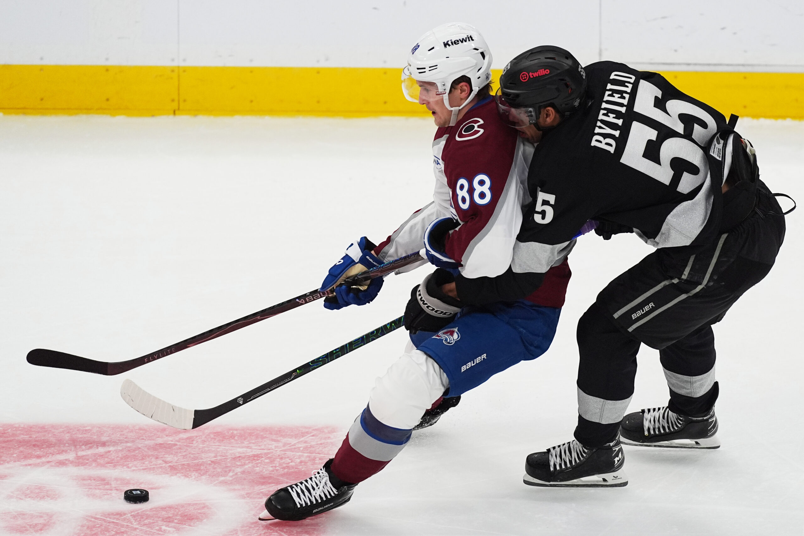 Colorado Avalanche center Martin Necas, left, struggles to control the...