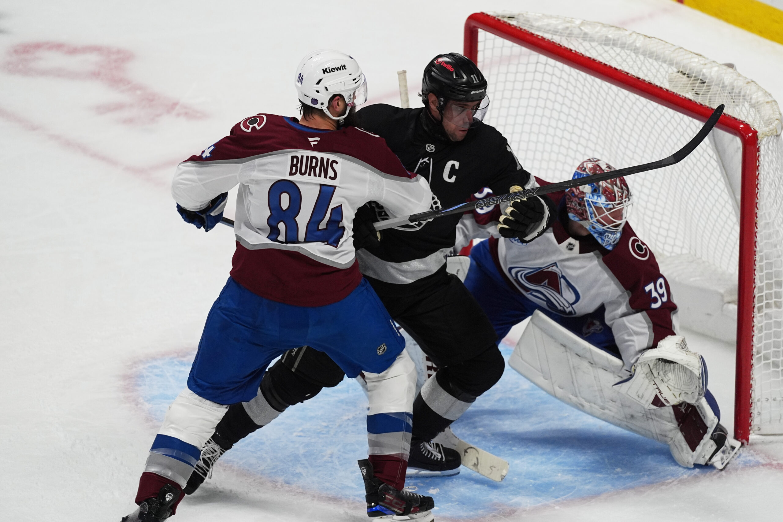 Kings center Anze Kopitar, center, drives between Colorado Avalanche defenseman...