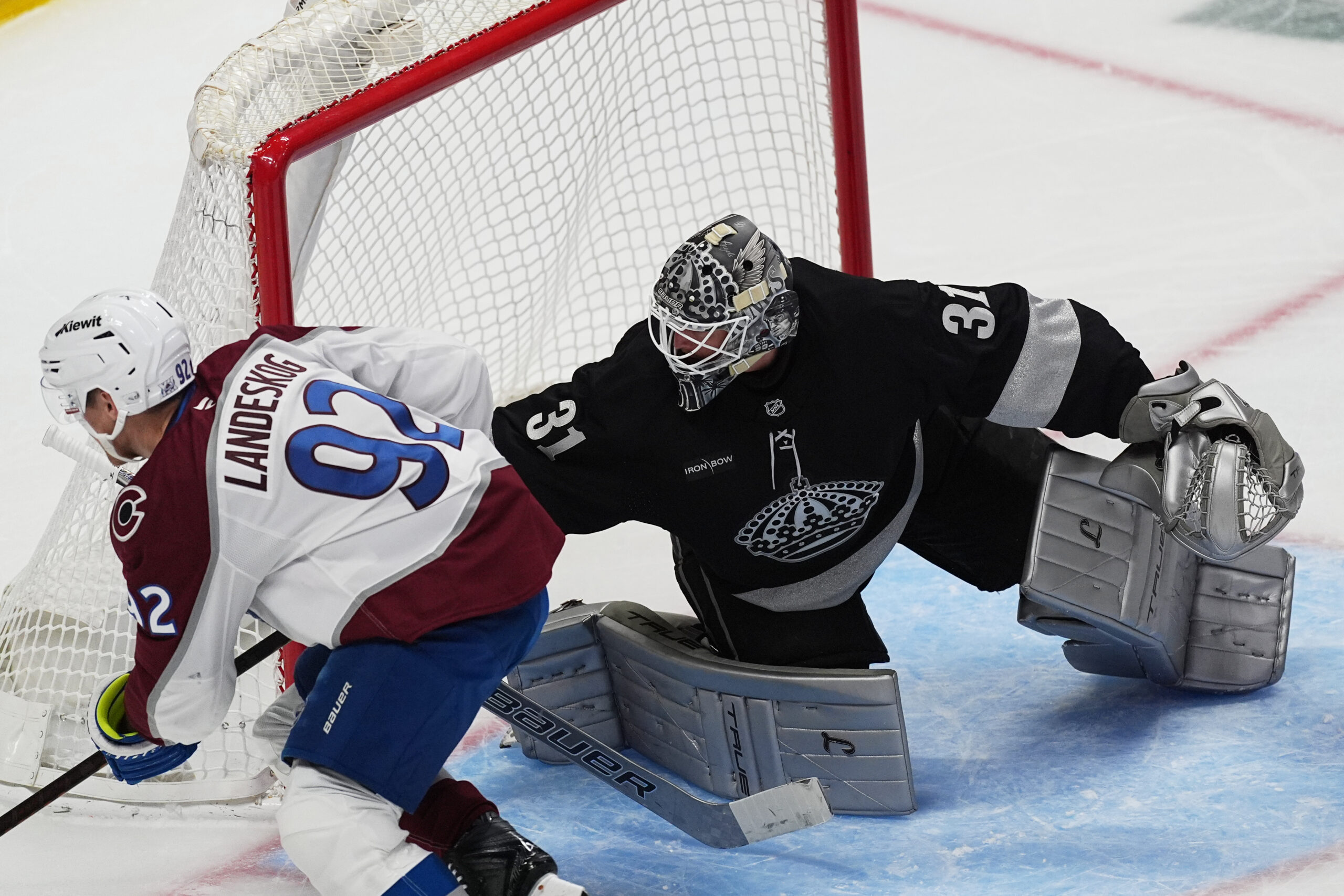 Kings goaltender Anton Forsberg, right, stops a shot by Colorado...