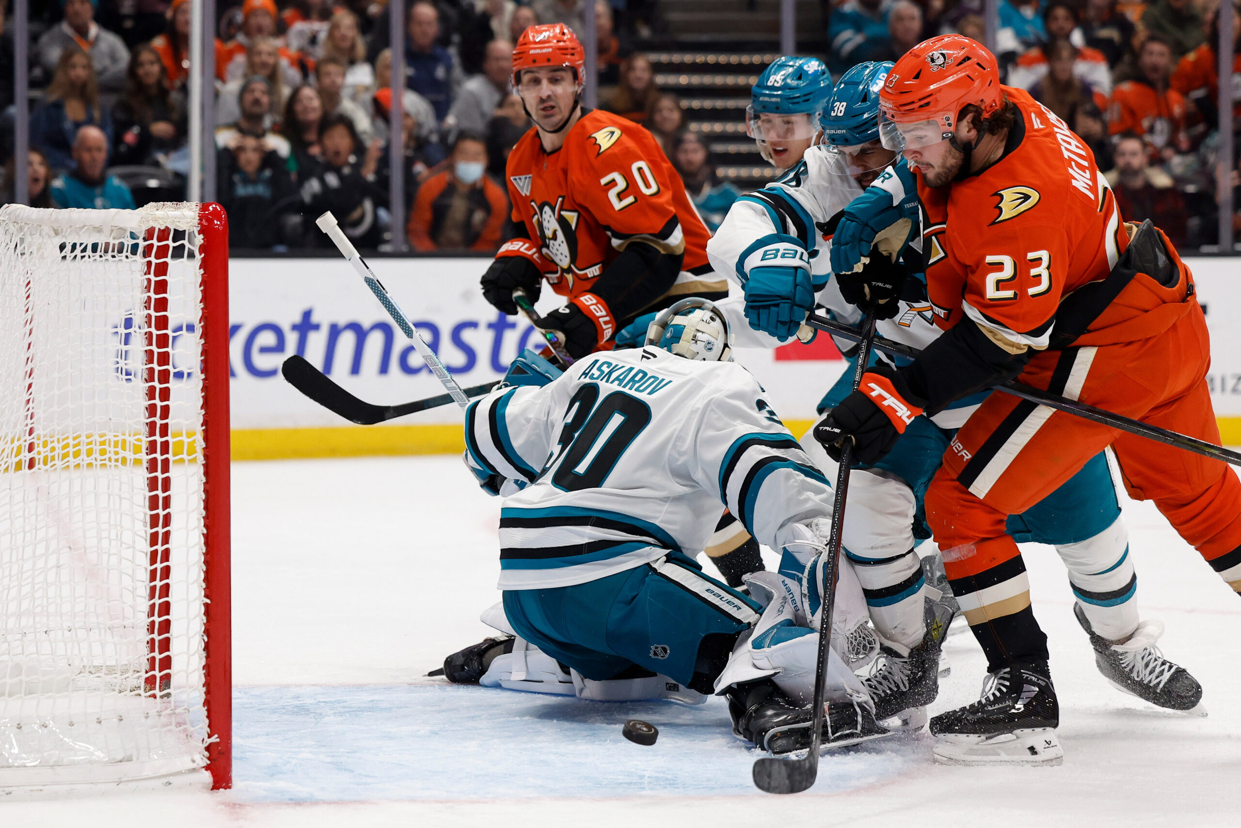 Ducks center Mason McTavish (23) takes a shot on goal...