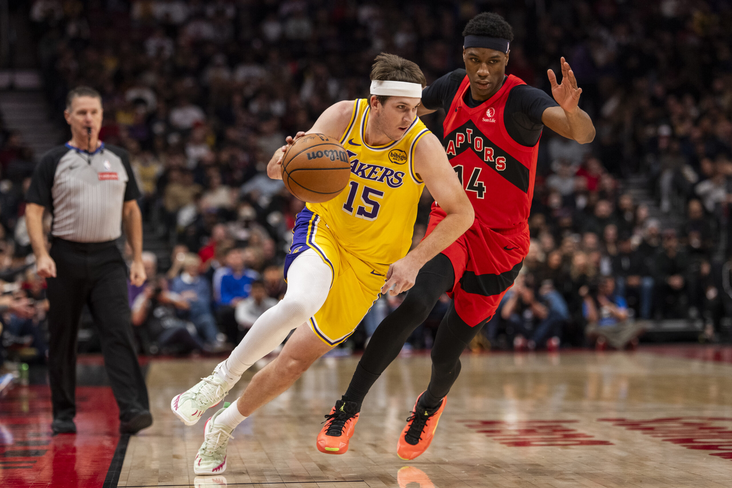 Lakers guard Austin Reaves drives as the Toronto Raptors’ Ja’Kobe...