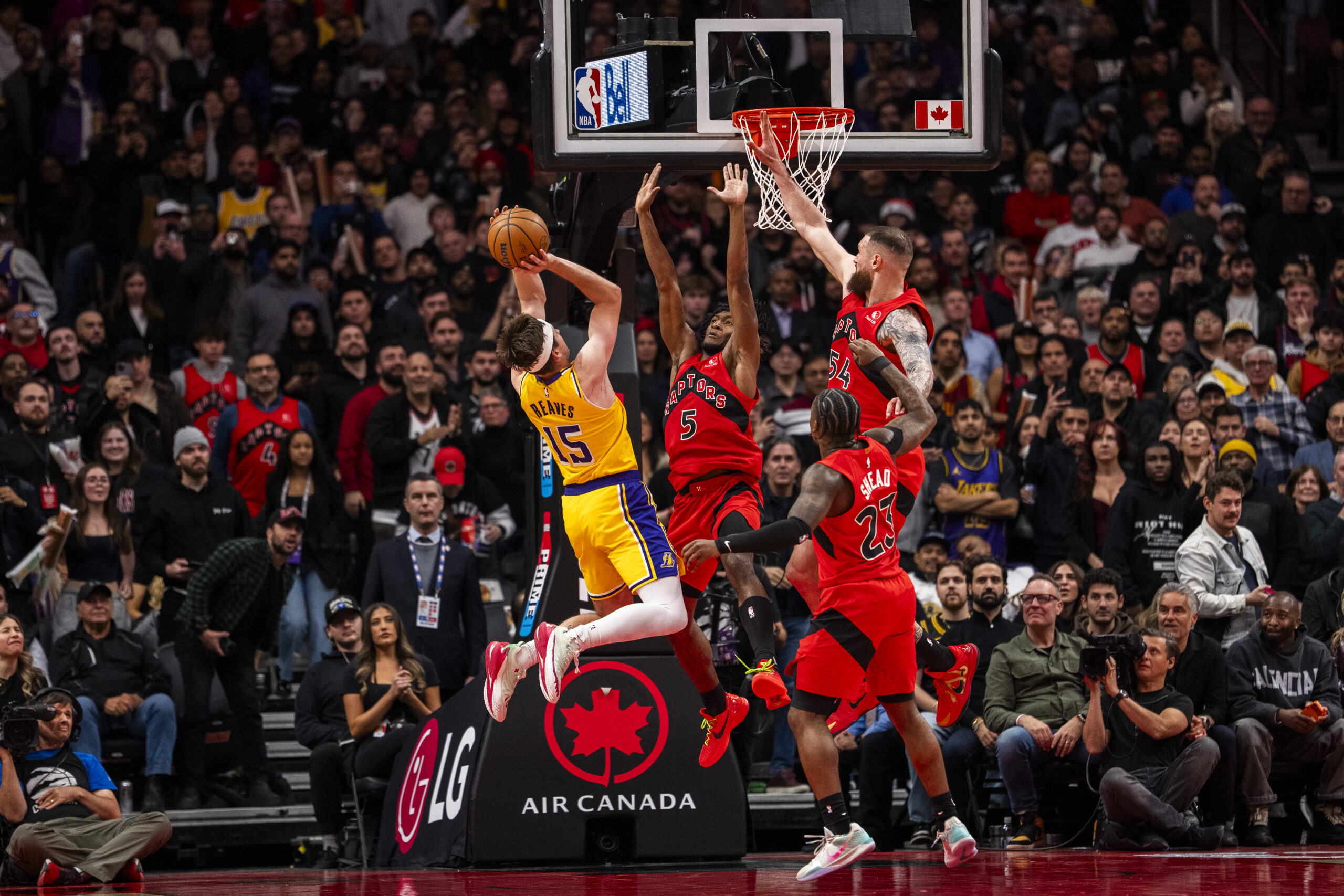 Lakers guard Austin Reaves shoots the ball as the Toronto...
