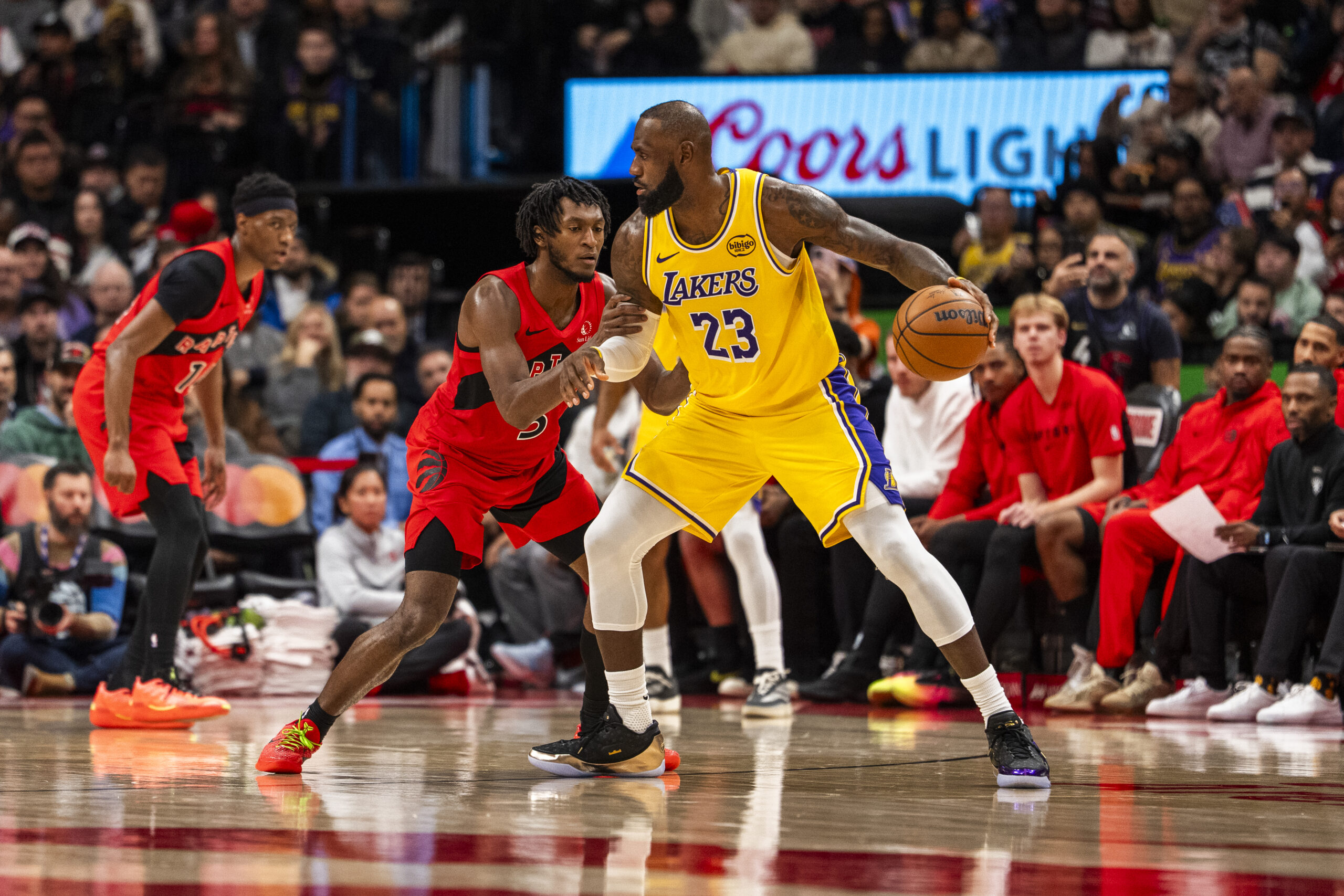 Lakers star LeBron James handles the ball as the Toronto...