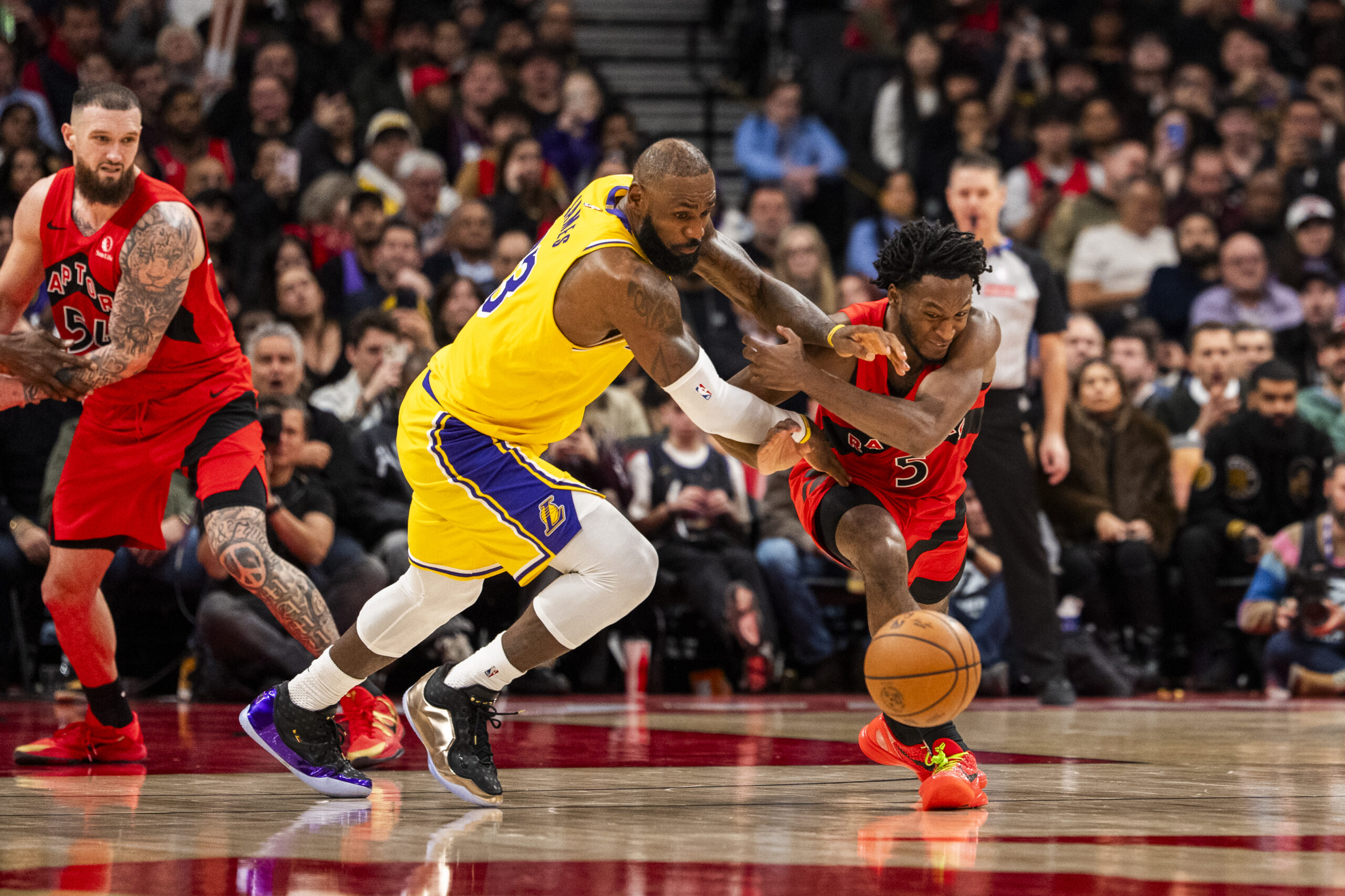 Lakers star LeBron James, left, battles for the ball against...