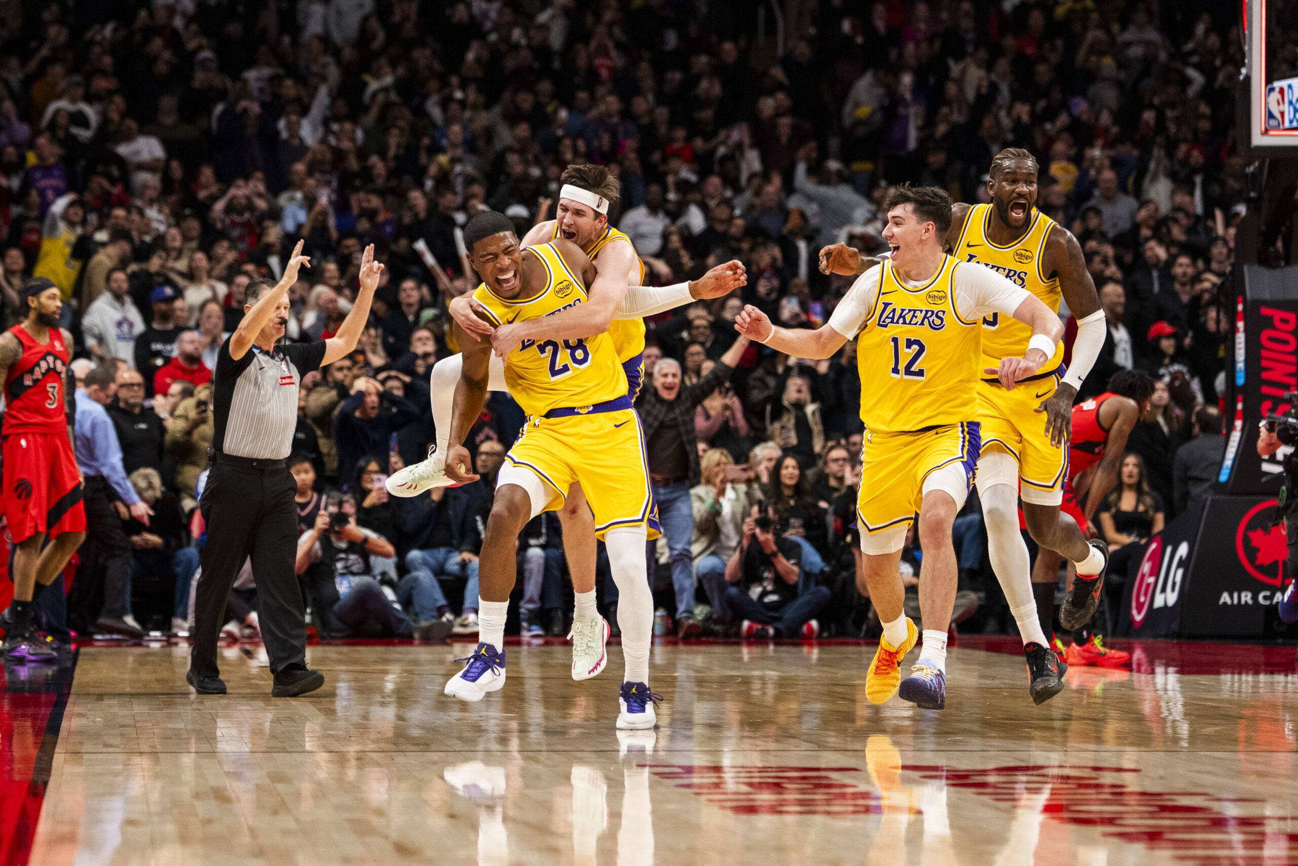 Lakers forward Rui Hachimura (28) celebrates with, from top left,...