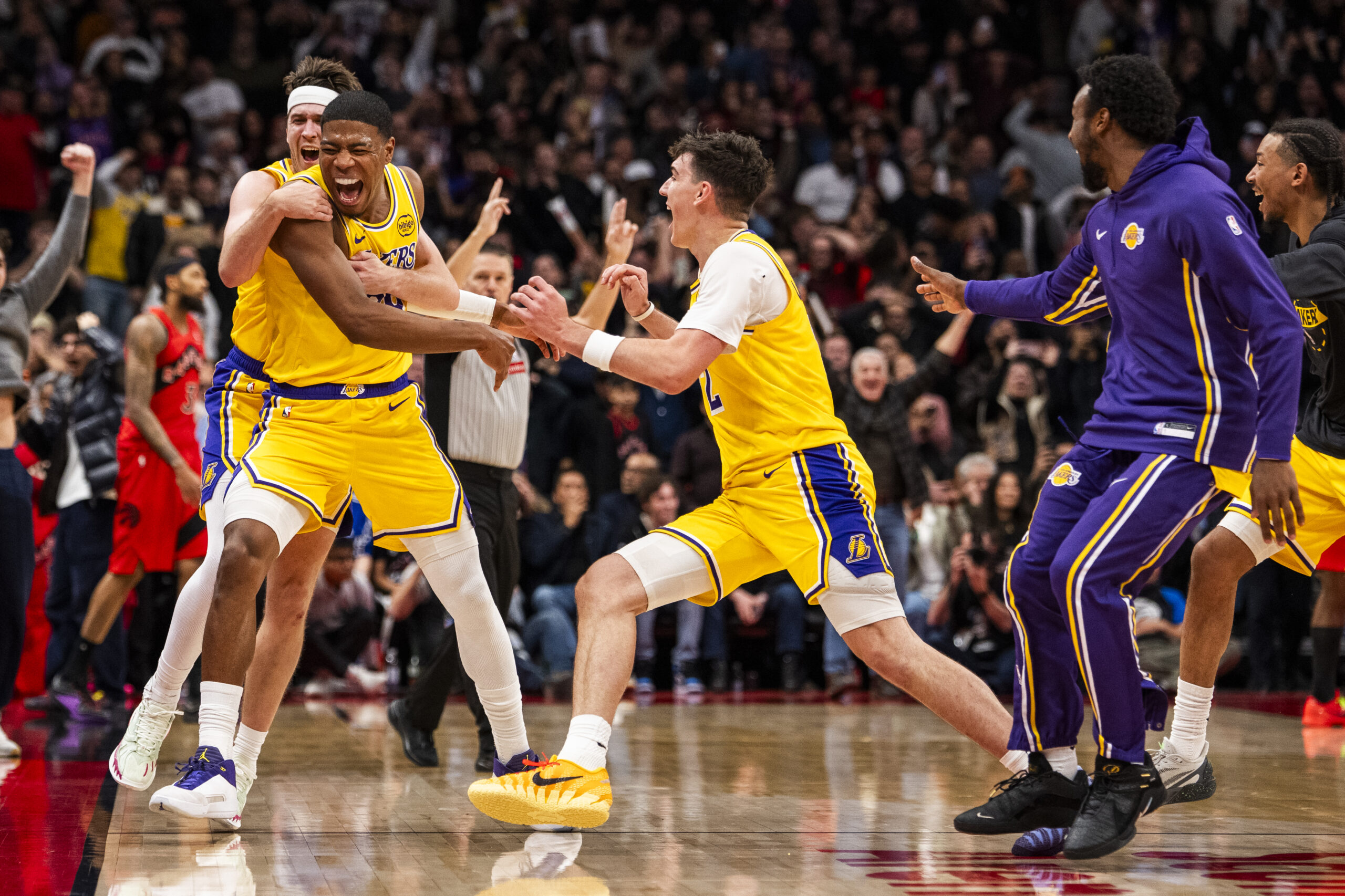 Lakers forward Rui Hachimura, front left, celebrates with teammates Austin...