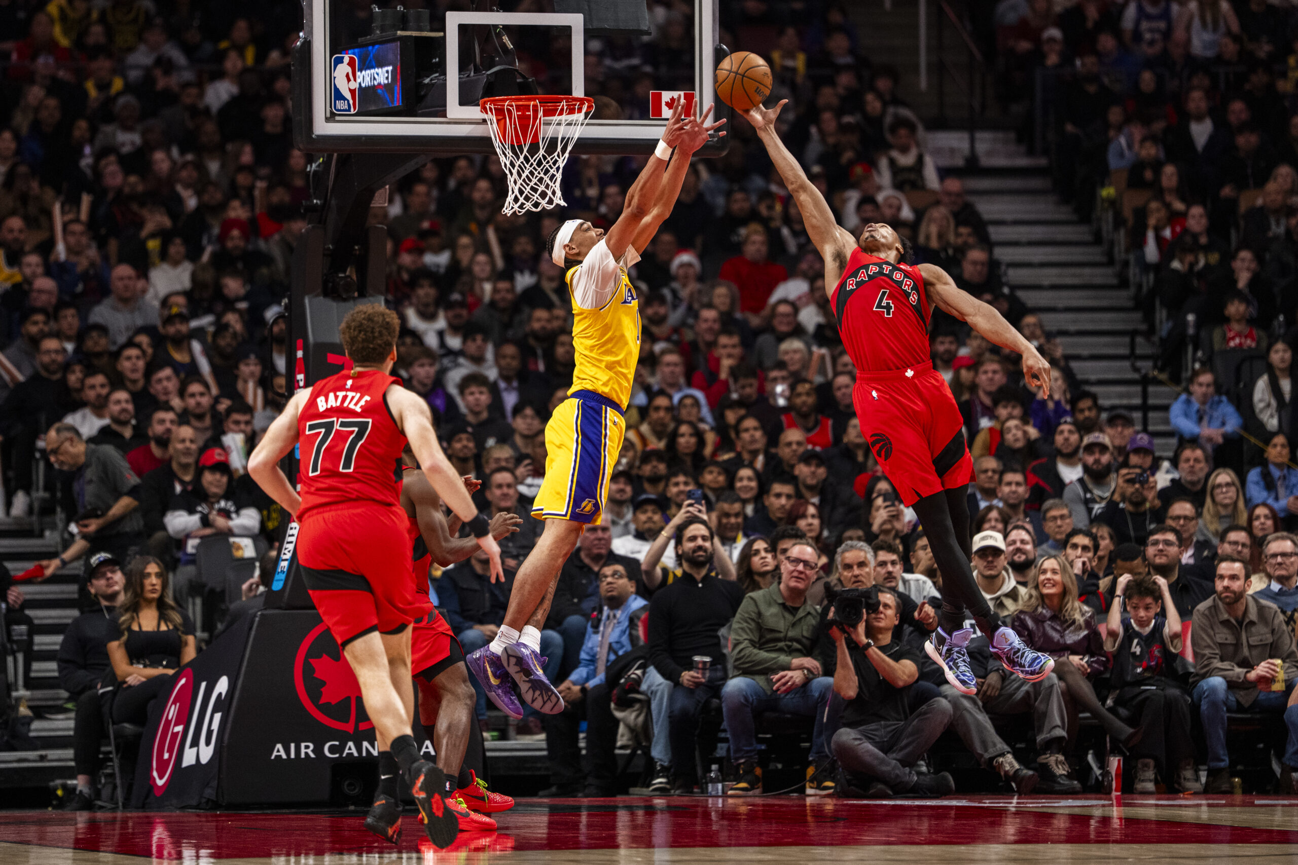 The Toronto Raptors’ Scottie Barnes, right, intercepts a pass intended...