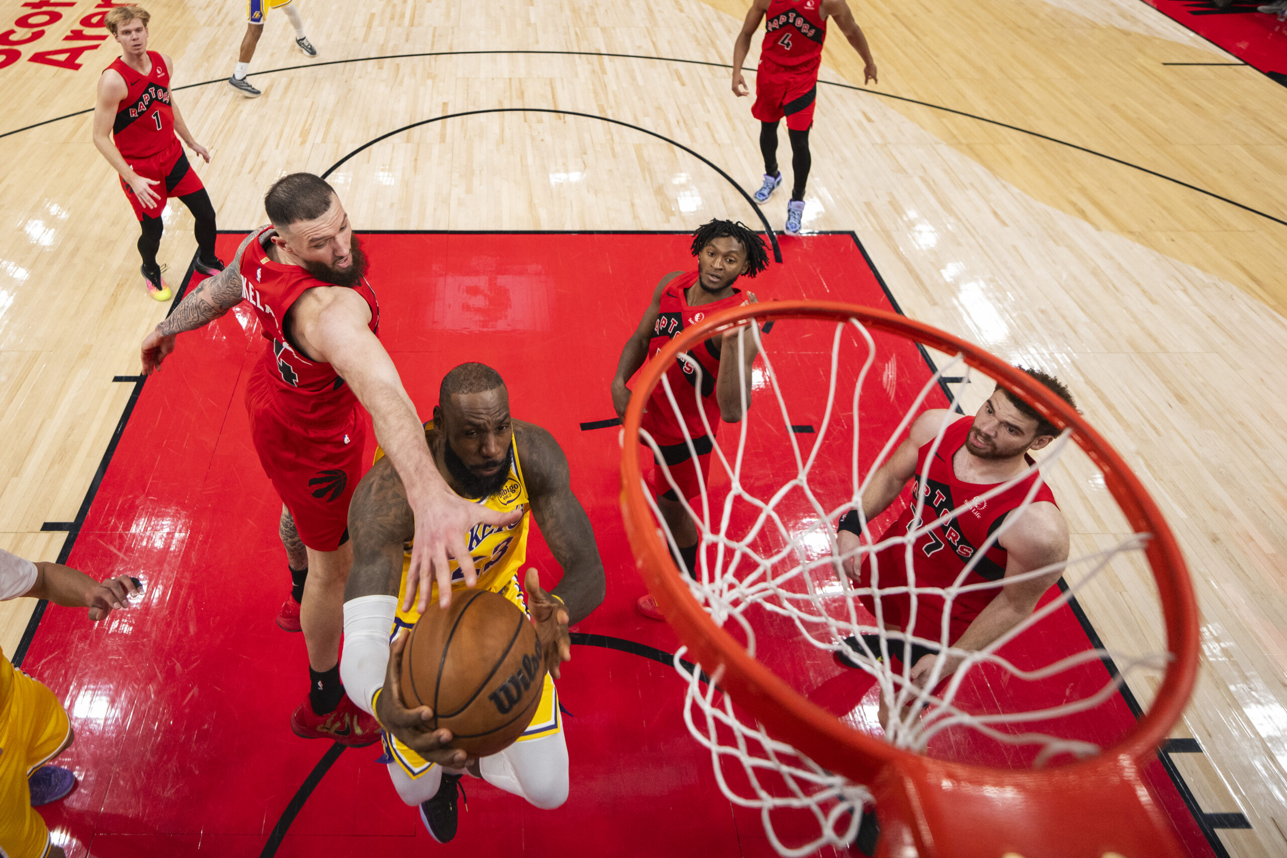 Lakers star LeBron James drives to the basket to shoot...