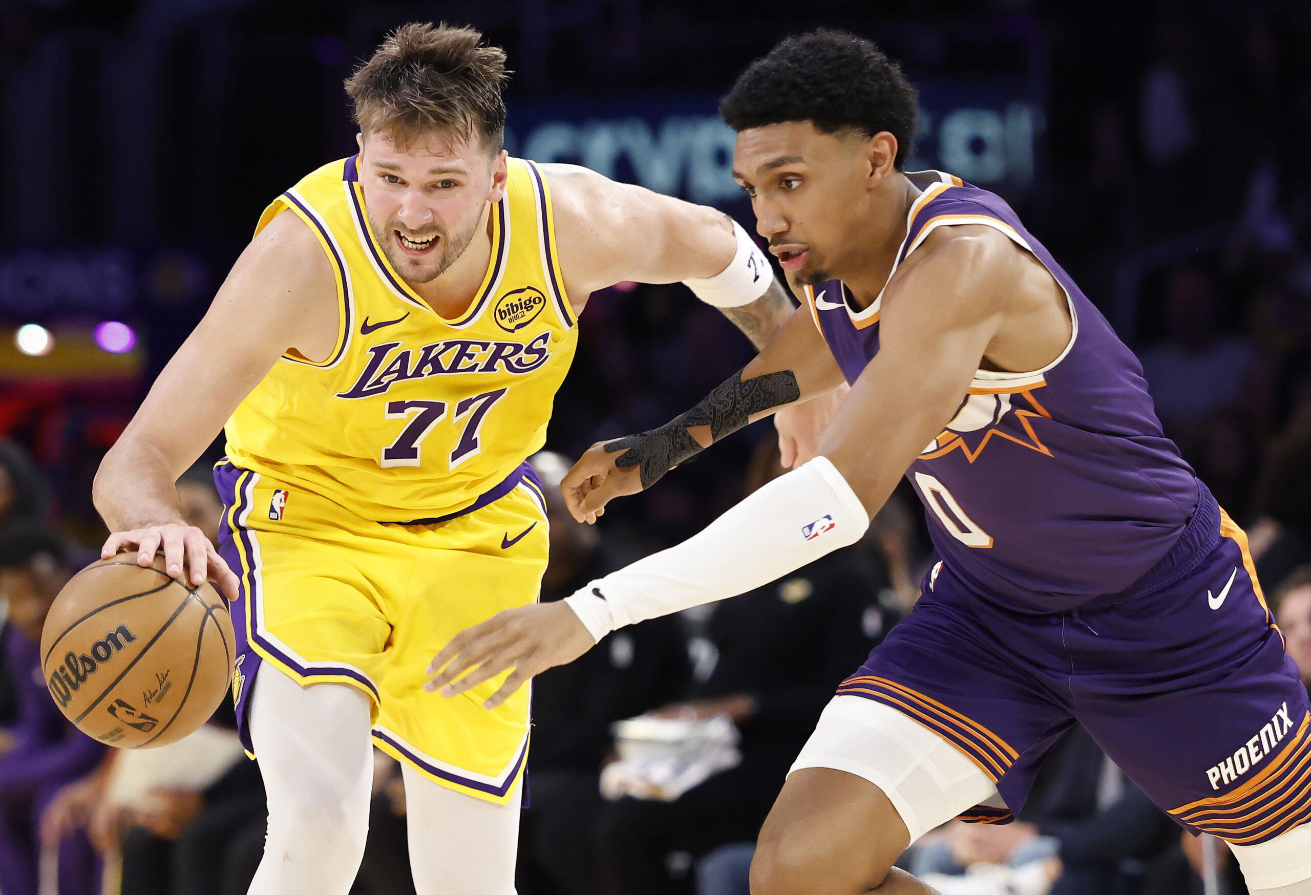 Lakers star Luka Doncic handles the ball as the Phoenix...