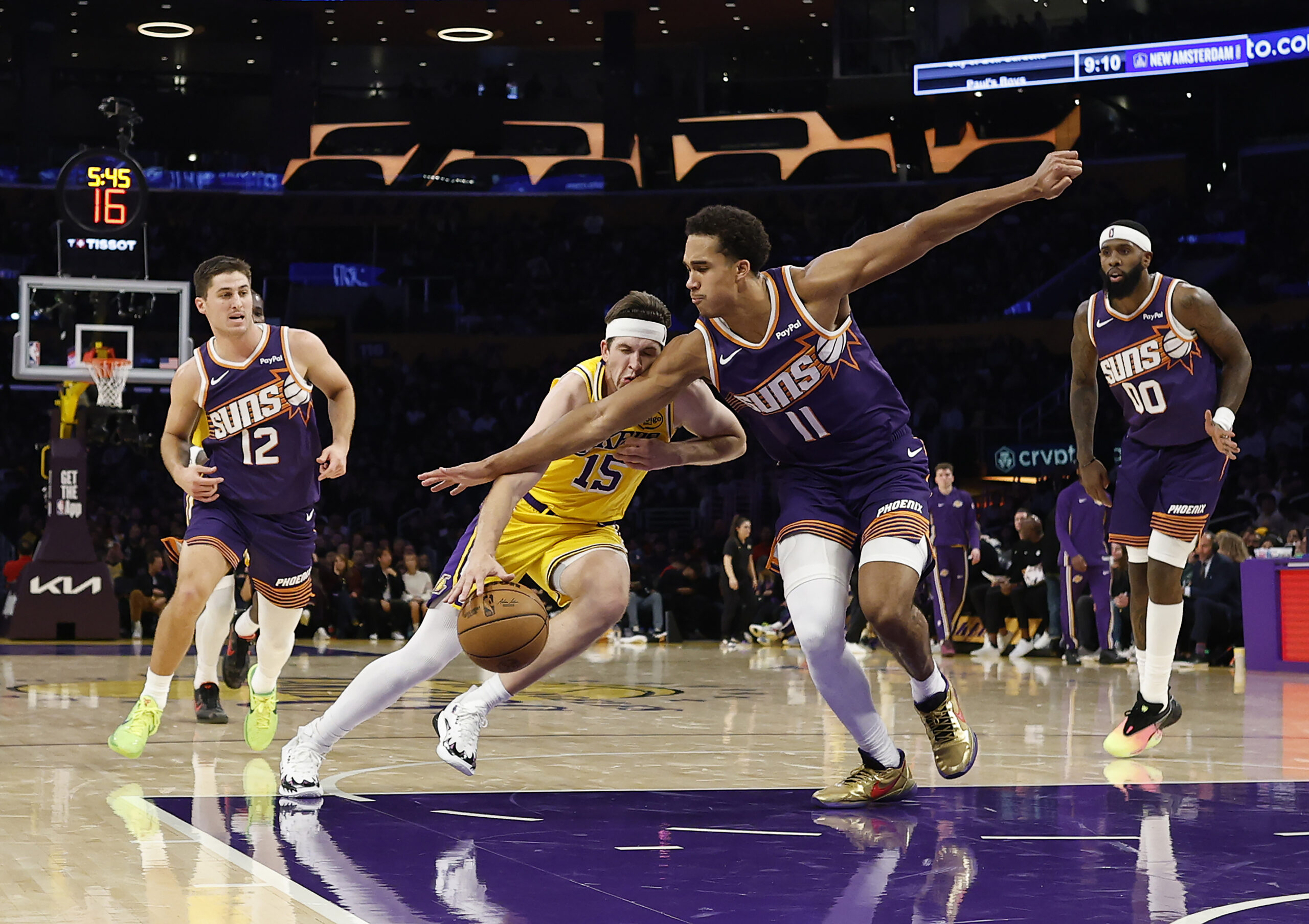 Lakers guard Austin Reaves drives as the Phoenix Suns’ Oso...