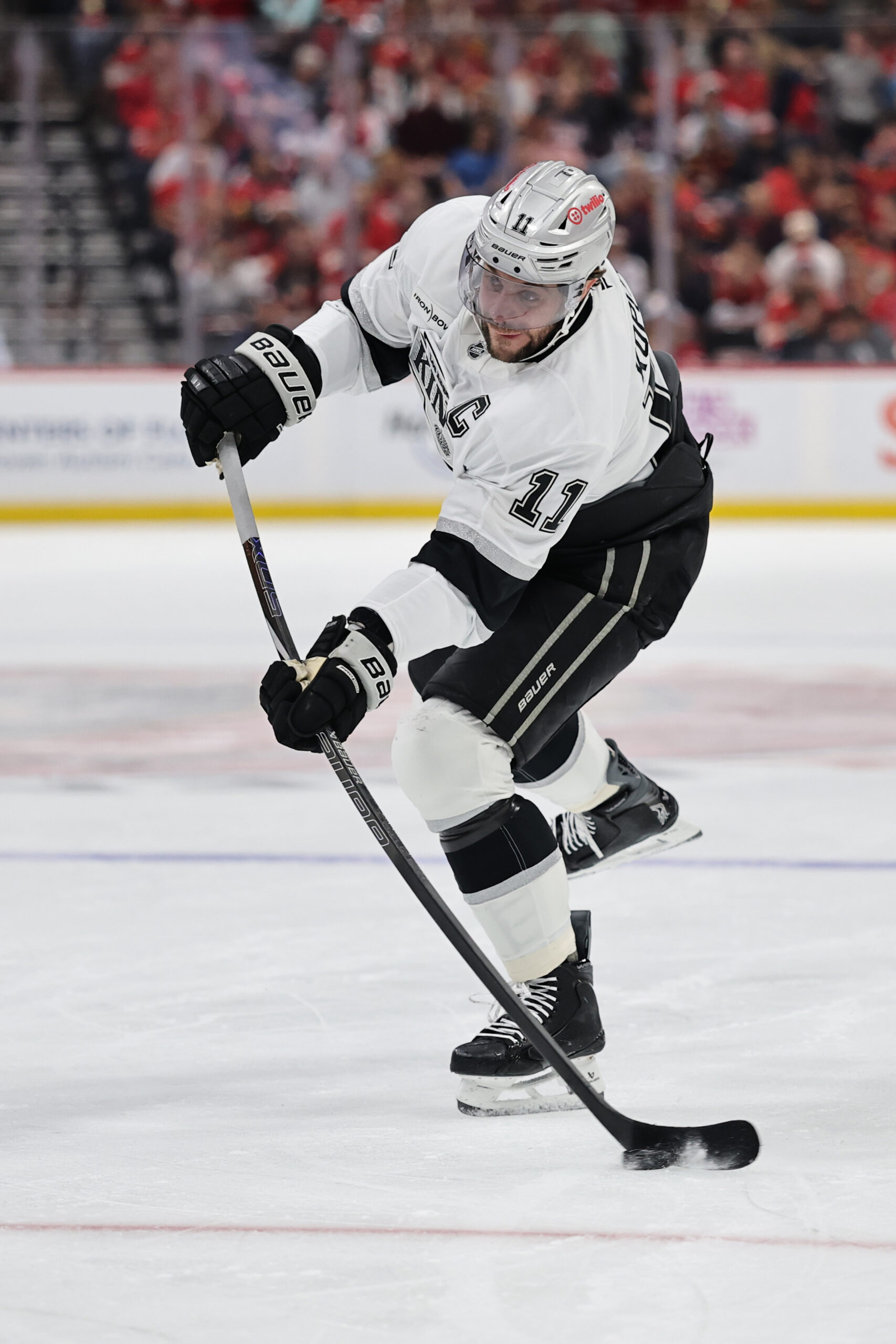 Kings captain Anze Kopitar fires the puck at the net...
