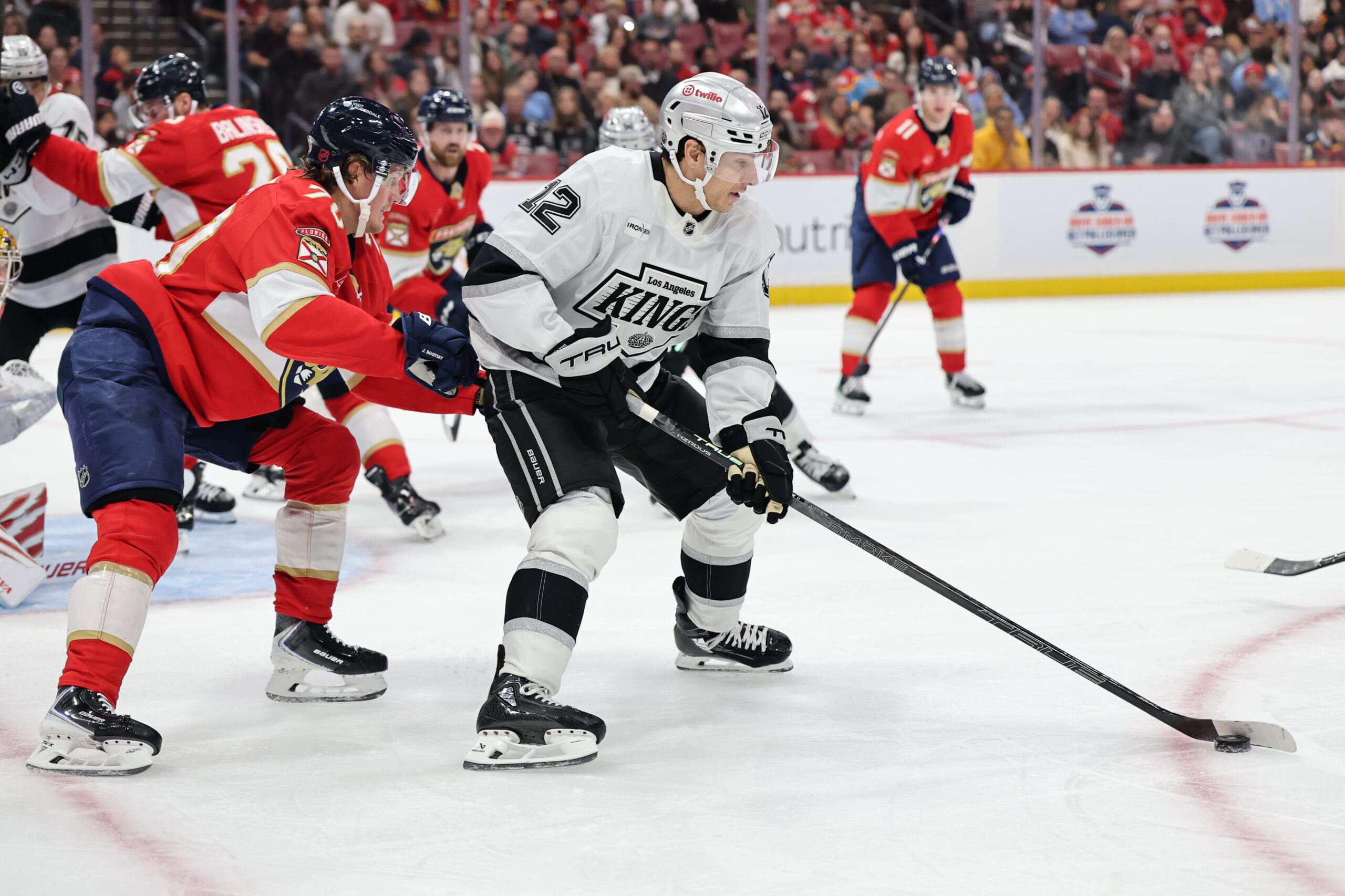 The Kings’ Trevor Moore controls the puck ahead of the...