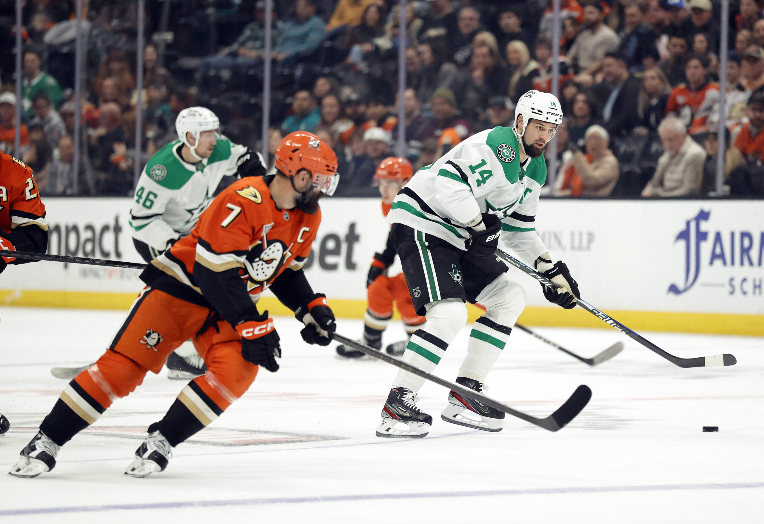 The Dallas Stars’ Jamie Benn, right, skates with the puck...