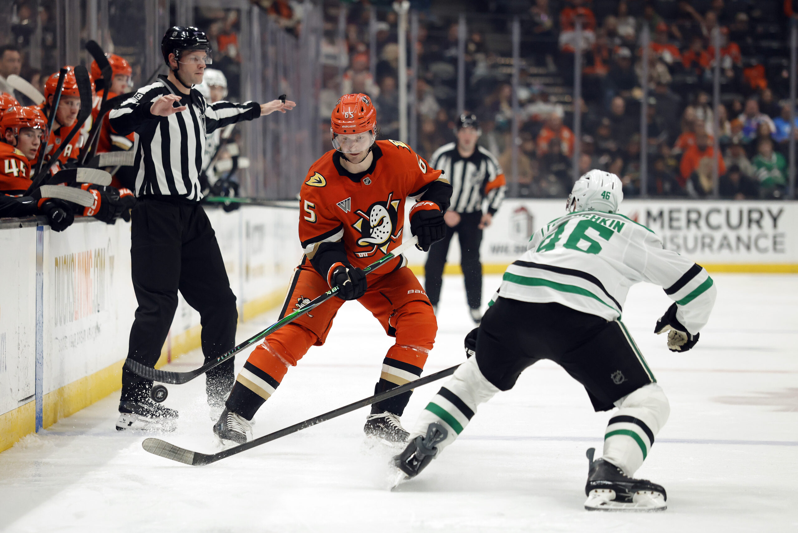 The Ducks’ Jacob Trouba, left, collects the puck as the...
