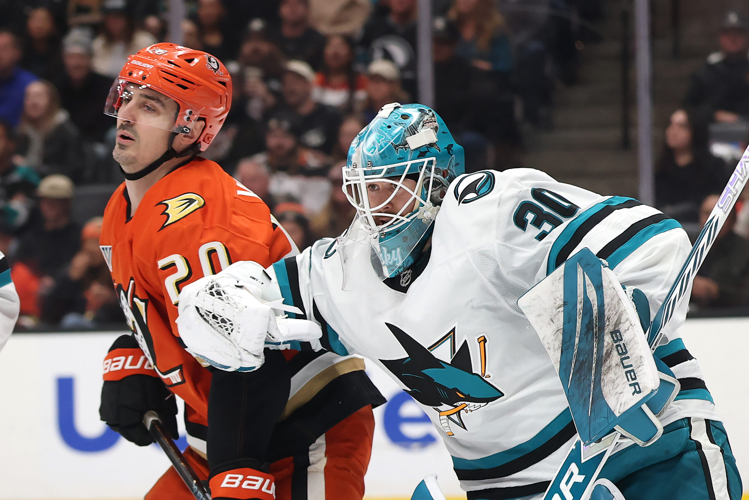 San Jose Sharks goaltender Yaroslav Askarov, right, pushes the Ducks’...