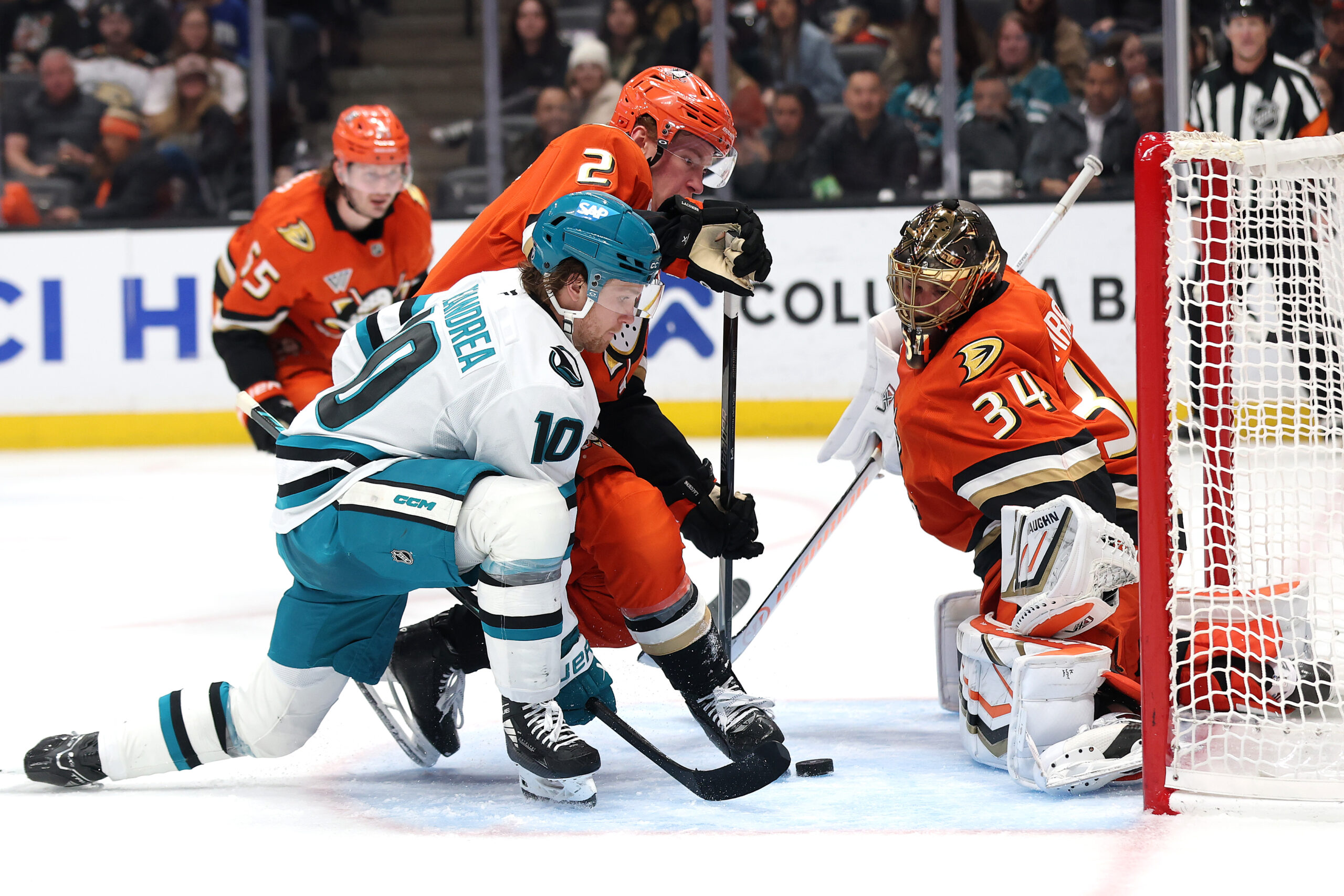 The Ducks’ Jackson Lacombe (2) and goaltender Petr Mrazek (34)...