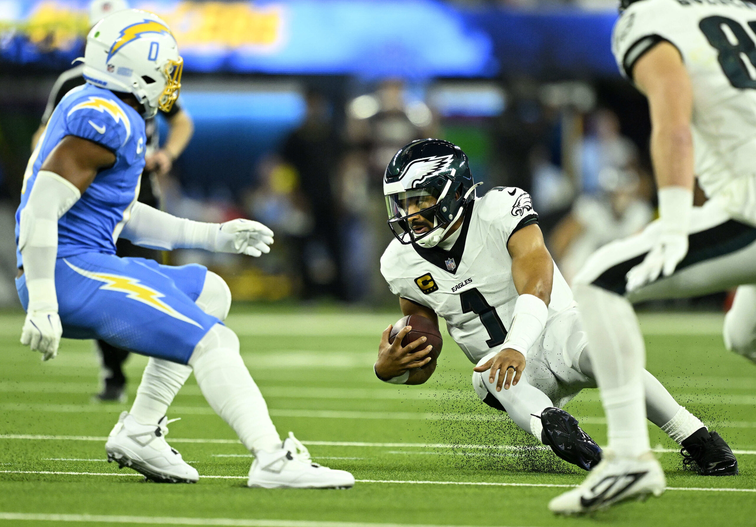 Philadelphia Eagles quarterback Jalen Hurts (1) goes down as he...