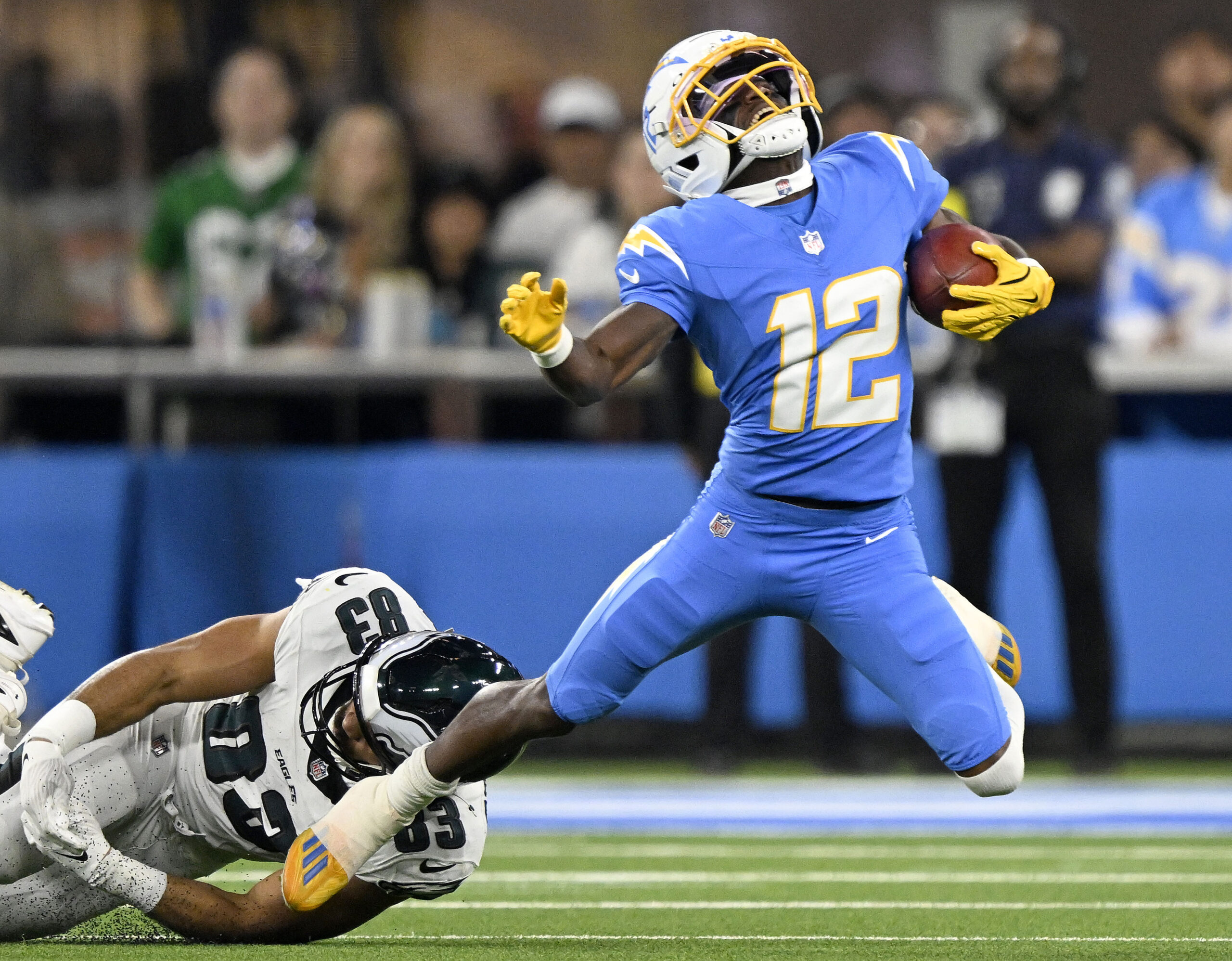 Chargers punt returner Derius Davis is tripped by the Philadelphia...