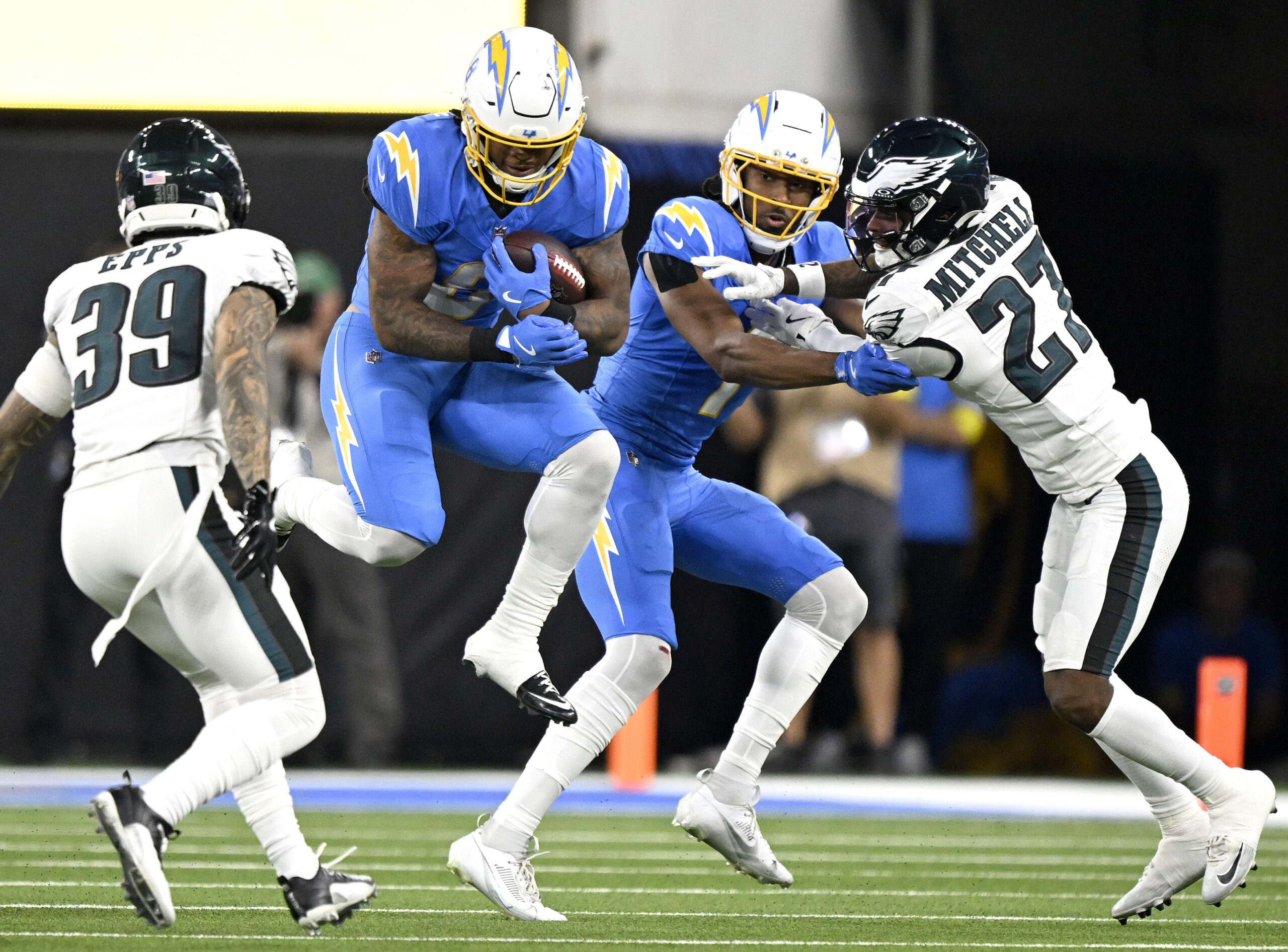 Chargers running back Omarion Hampton (8) leaps as he finds...