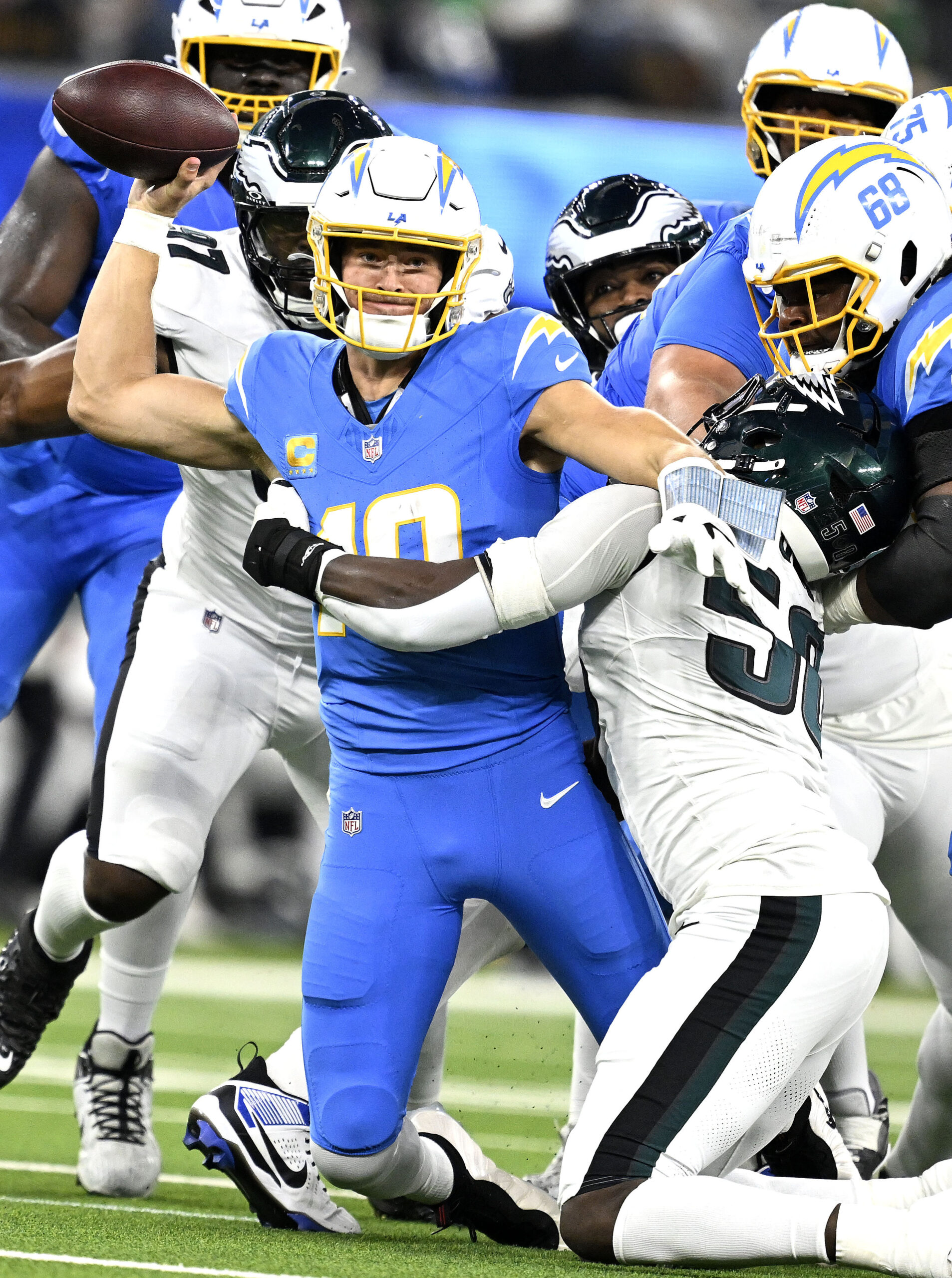 Chargers quarterback Justin Herbert (10) is pressured by the Philadelphia...
