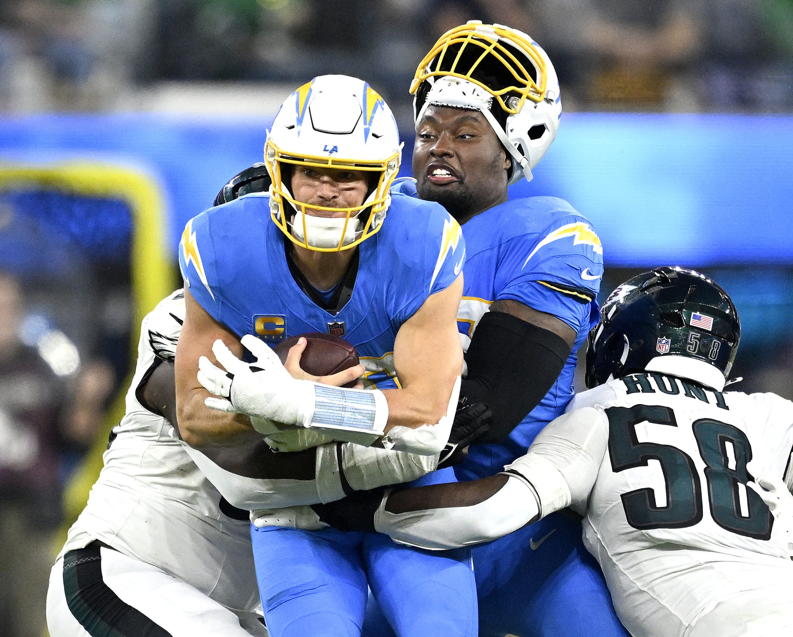 Chargers quarterback Justin Herbert (10) is hit by the Philadelphia...